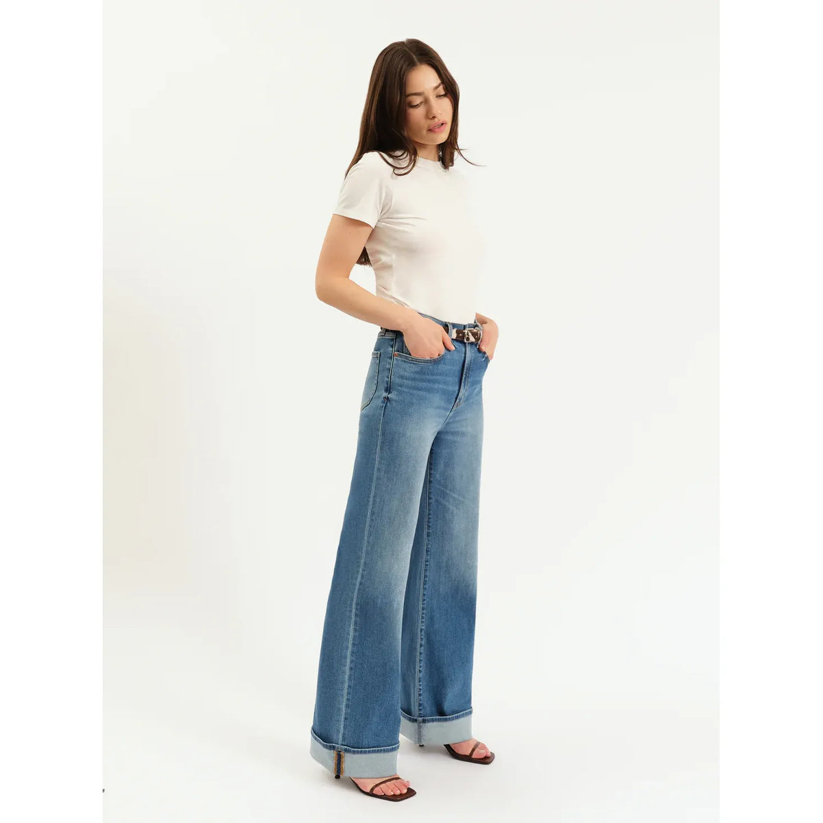 Daze Far Out High Rise Wide Leg jeans in Big Break on a model; light blue denim with pre-rolled cuffs in Hug fabric.