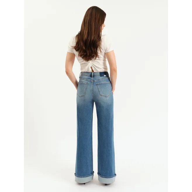Back view of model wearing Daze Far Out High Rise Wide Leg in Big Break jeans with pre-rolled cuffs.