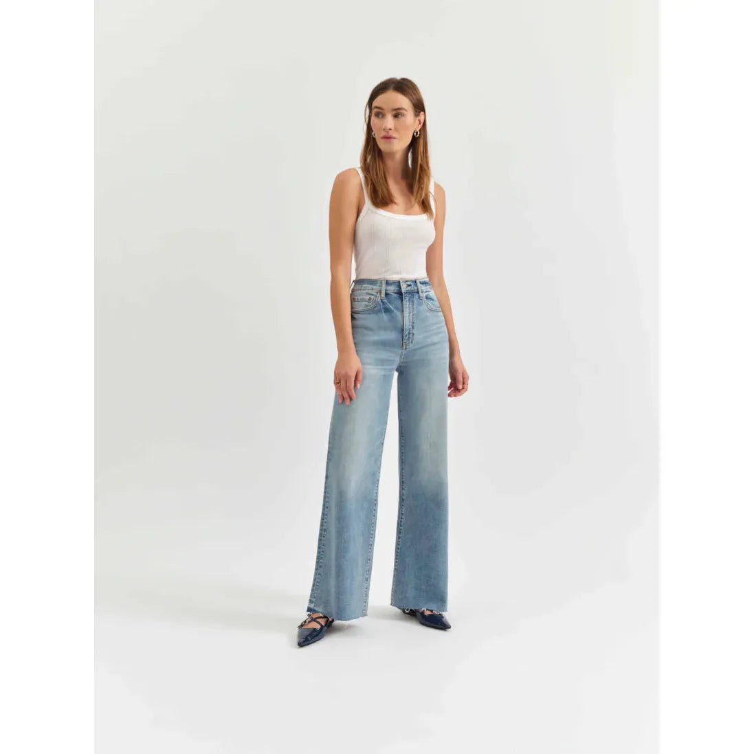 Daze Far Out High Rise Wide Leg in Fools Gold jeans showcase a vintage vibe with scissor-cut hems and a light wash.