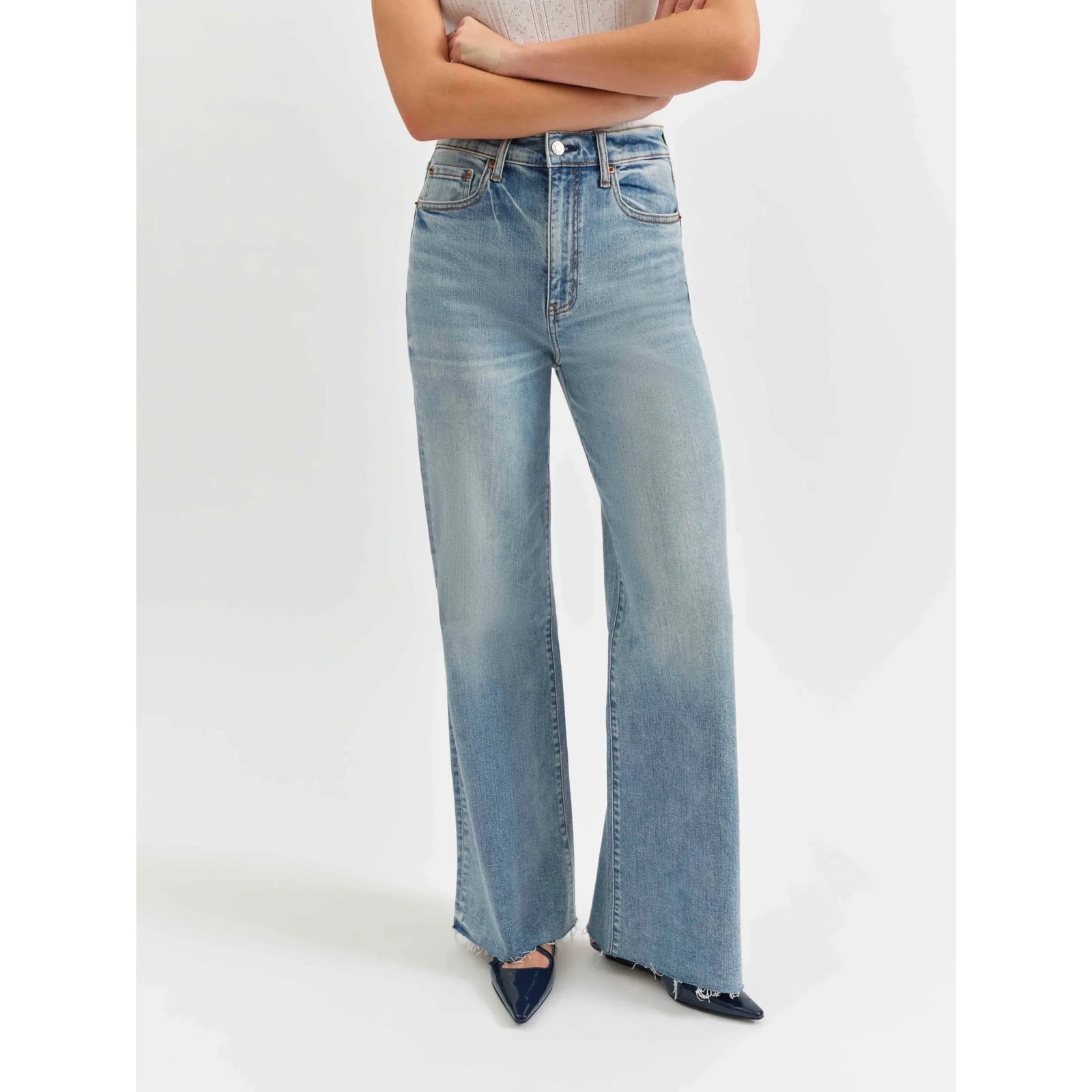 Daze Far Out High Rise Wide Leg in Fools Gold jeans showcase a vintage vibe with scissor-cut hems and a light wash.