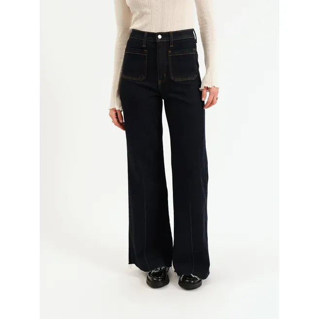 Daze Far Out High Rise Wide Leg jeans in Rinse on a model wearing a cream knit top.