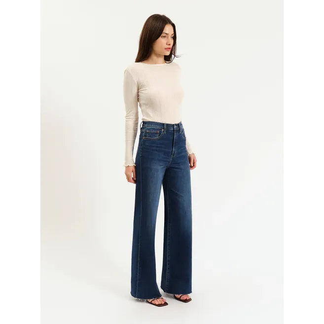 Daze Far Out High Rise Wide Leg Waterfall jeans on a model in dark denim with a beige top — Daze.