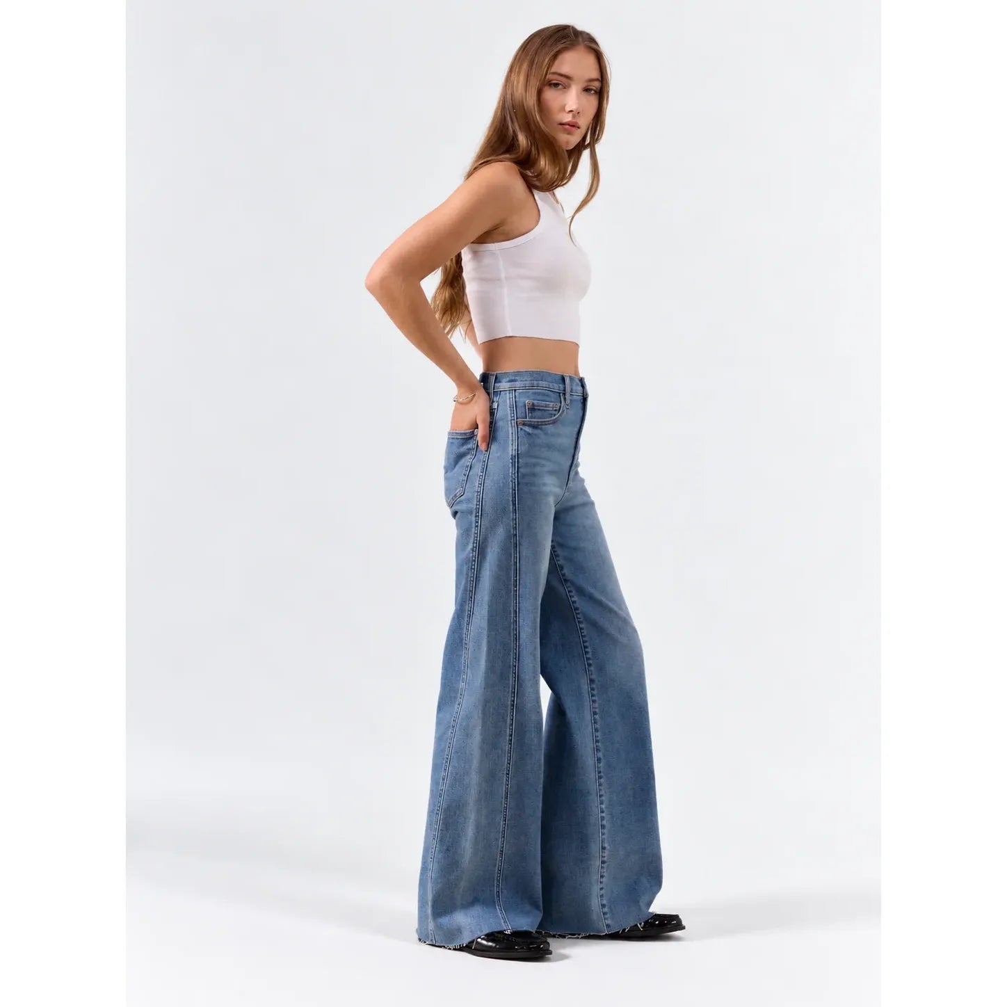 Daze Far Out high rise wide leg jeans in vintage wash featuring paneled seams and raw hem.