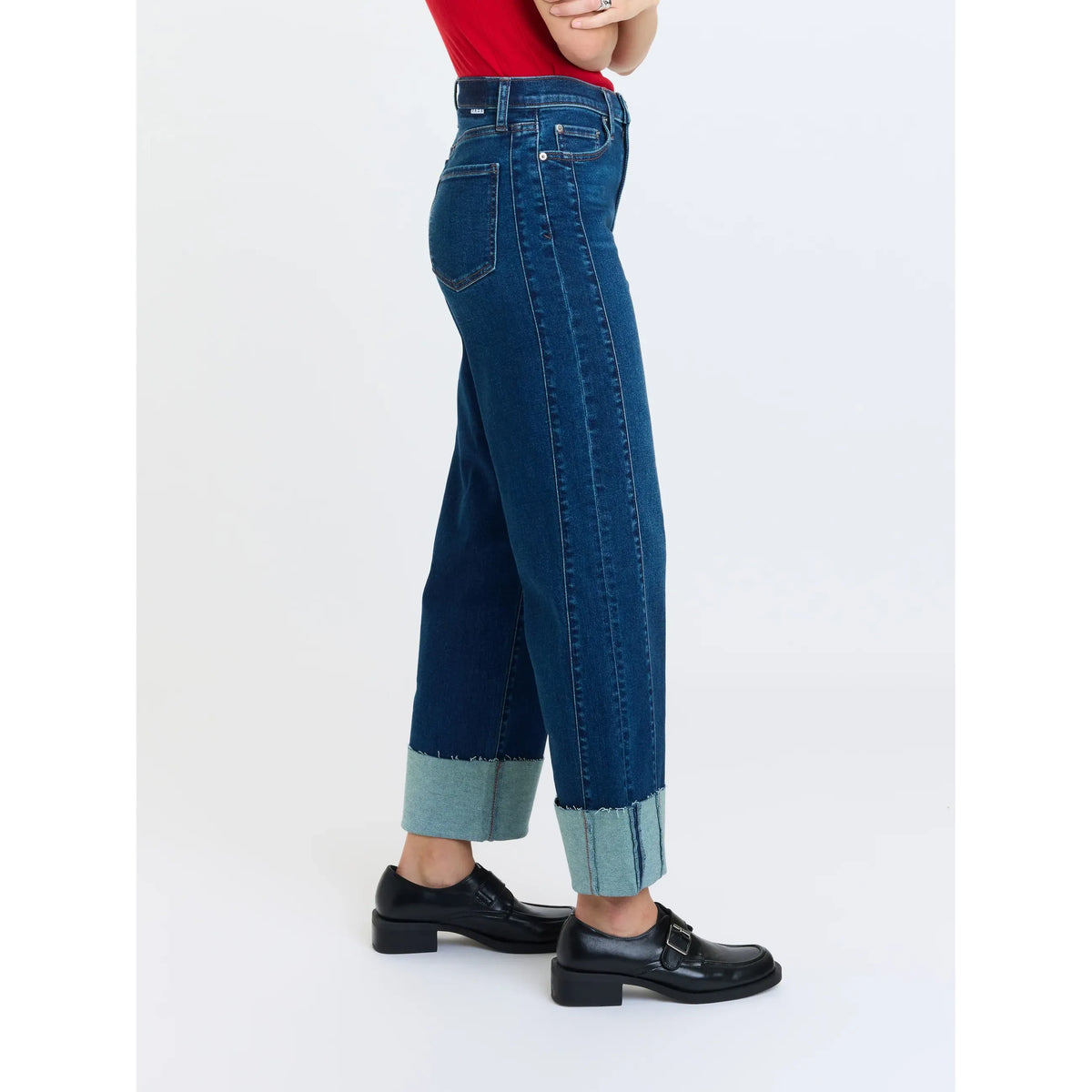 High-rise wide leg ankle jeans with contrast seam detailing, cuffed hem, and stretch denim fit paired with black loafers.