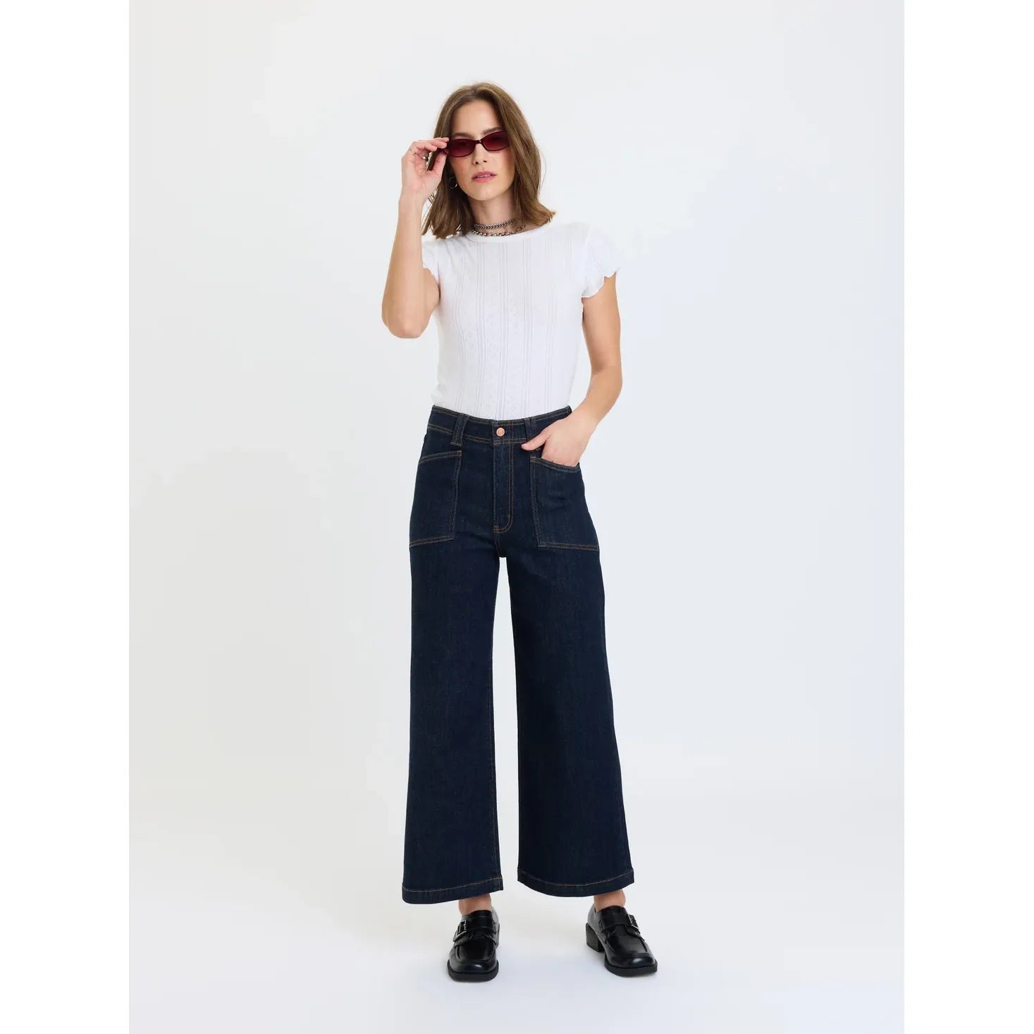High-rise wide leg ankle jeans in rinse with vintage front patch pockets and deep indigo wash.
