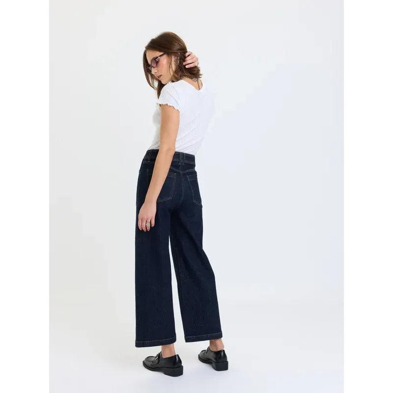 High-rise wide leg ankle jeans in deep indigo rinse wash featuring vintage front patch pockets and comfortable stretch denim.
