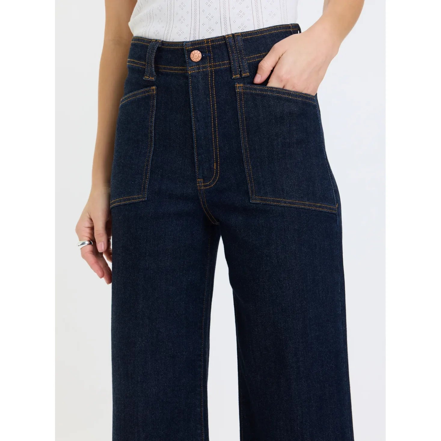 High-rise wide leg ankle jeans in deep indigo rinse featuring vintage-inspired front patch pockets and comfort stretch denim.