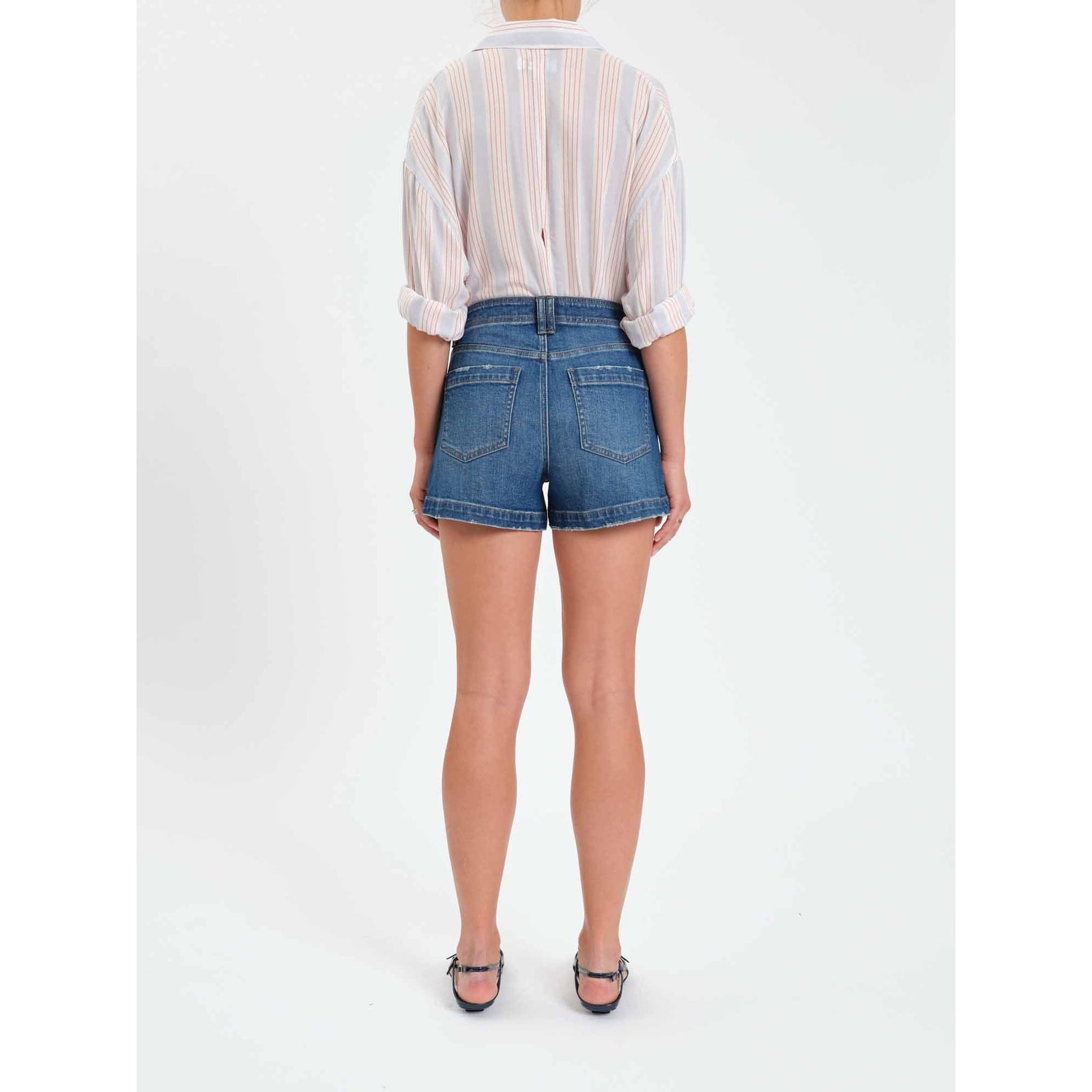 Back view of a model wearing Daze Valley Girl Short in Manhattan denim shorts with high-rise waist and back pockets.