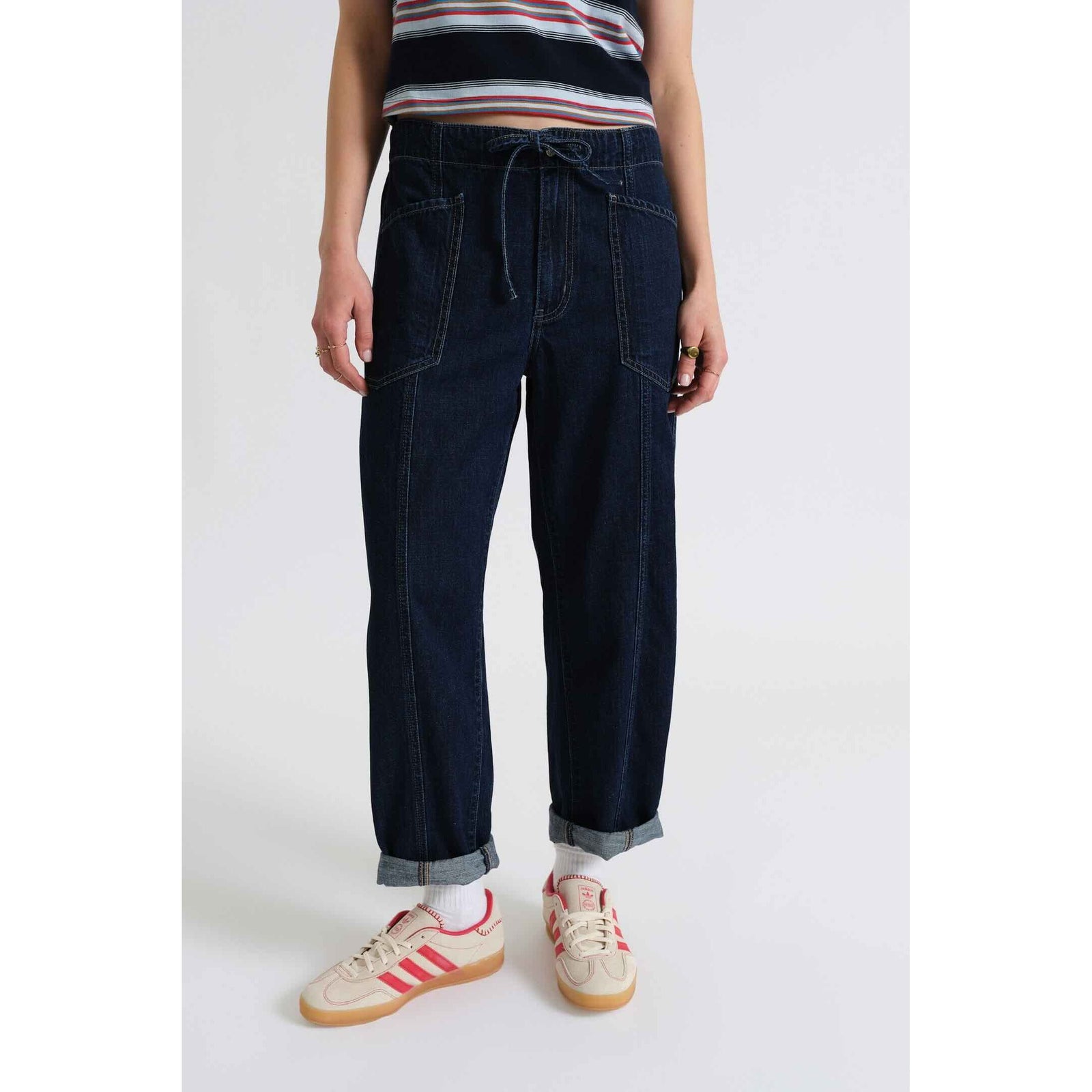 Model wearing Blue Mood Daze Villa Drawstring Barrel pants, rolled cuffs, striped top, sneakers.