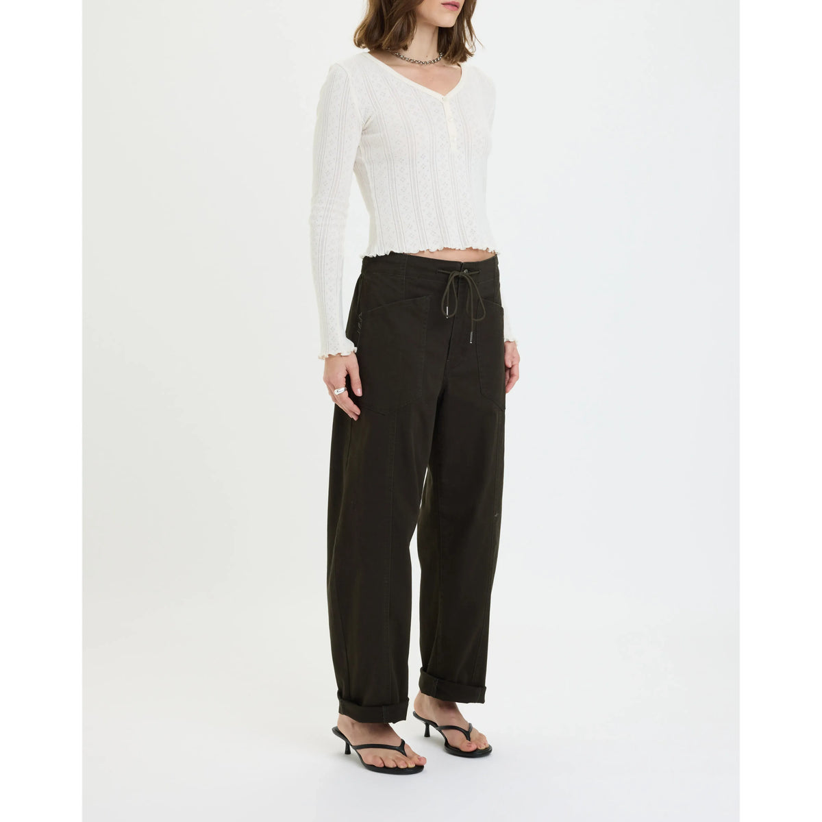Model wearing Daze Villa Drawstring Barrel Pant in Fern with a tapered silhouette and drawstring waist.