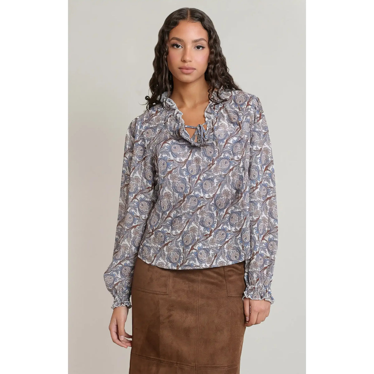 Floral print balloon sleeved blouse with a V-neckline and tie detail, featuring fluid sleeves and ruffled cuffs for elegant movement.