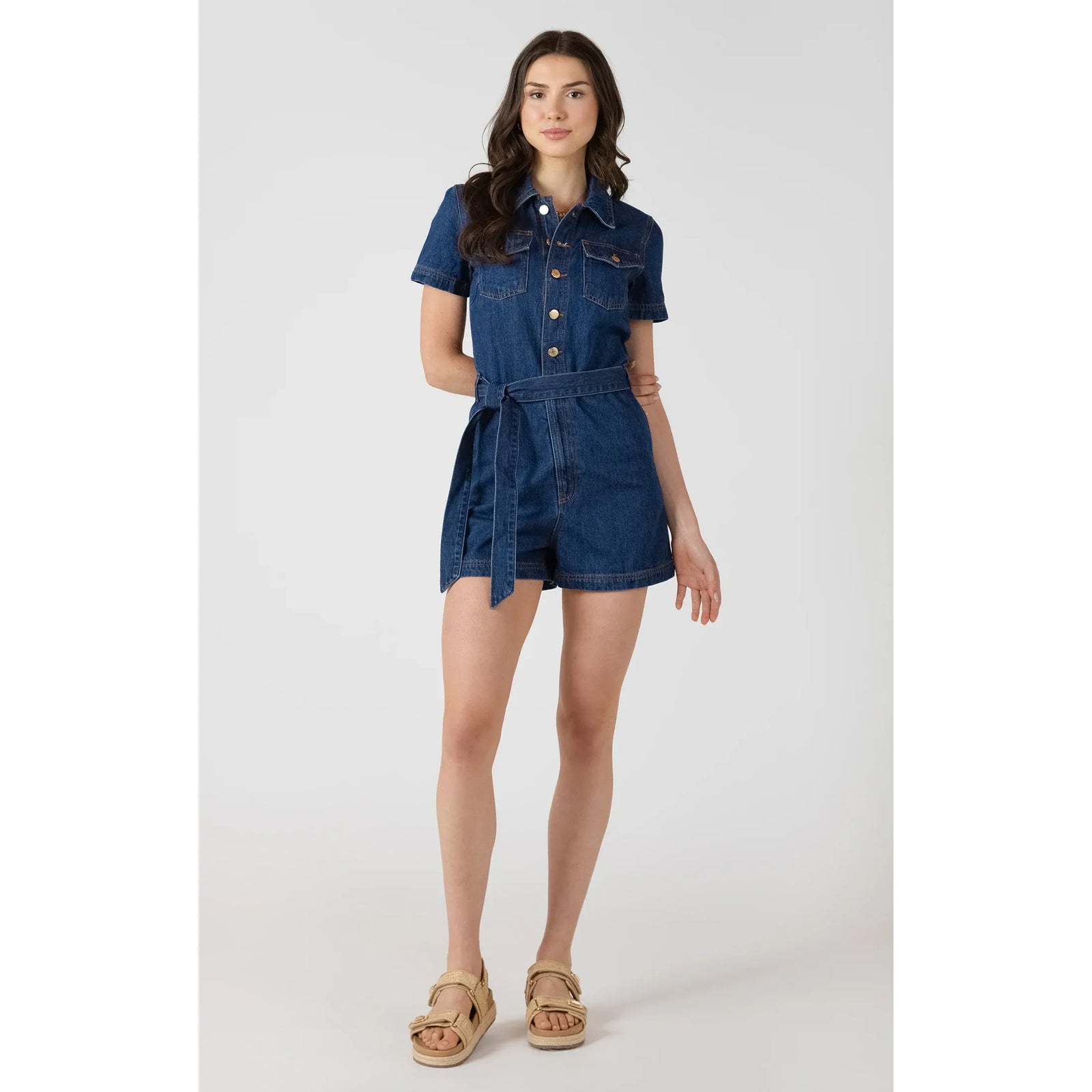Dex Belted Utility Romper in medium indigo with waist belt and utility-style pockets.