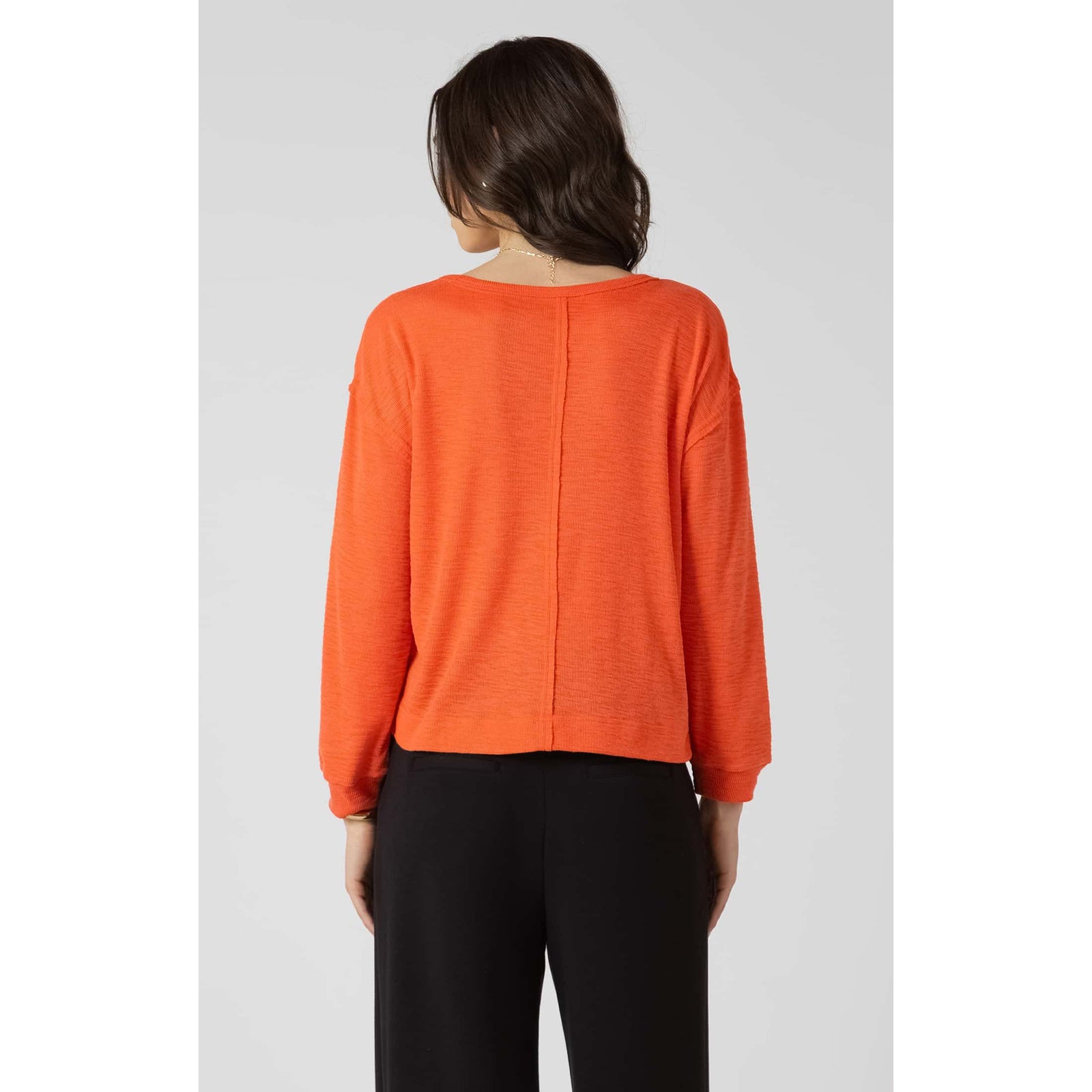 Dex Crewneck Sweatshirt in bright orange, lightweight long-sleeve with chest pocket, worn by model.