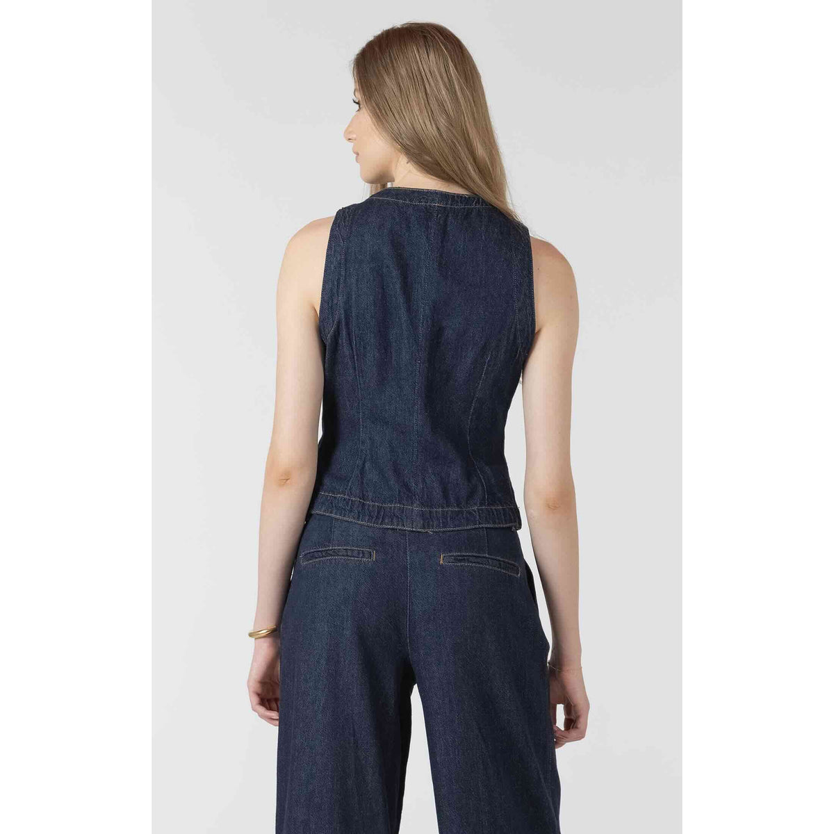 Dex Black Tape Denim Vest in dark indigo, sleeveless with classic button-up styling, back view on model.