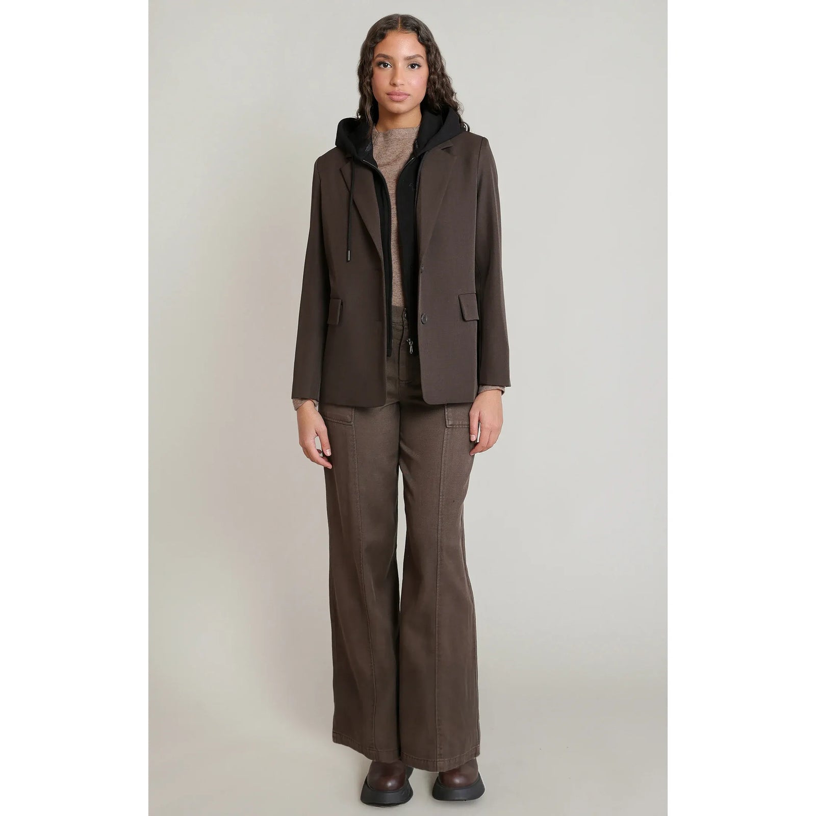 Dex Hooded Blazer in dark brown with a detachable black hood, model wearing layered for a polished rugged fall look.