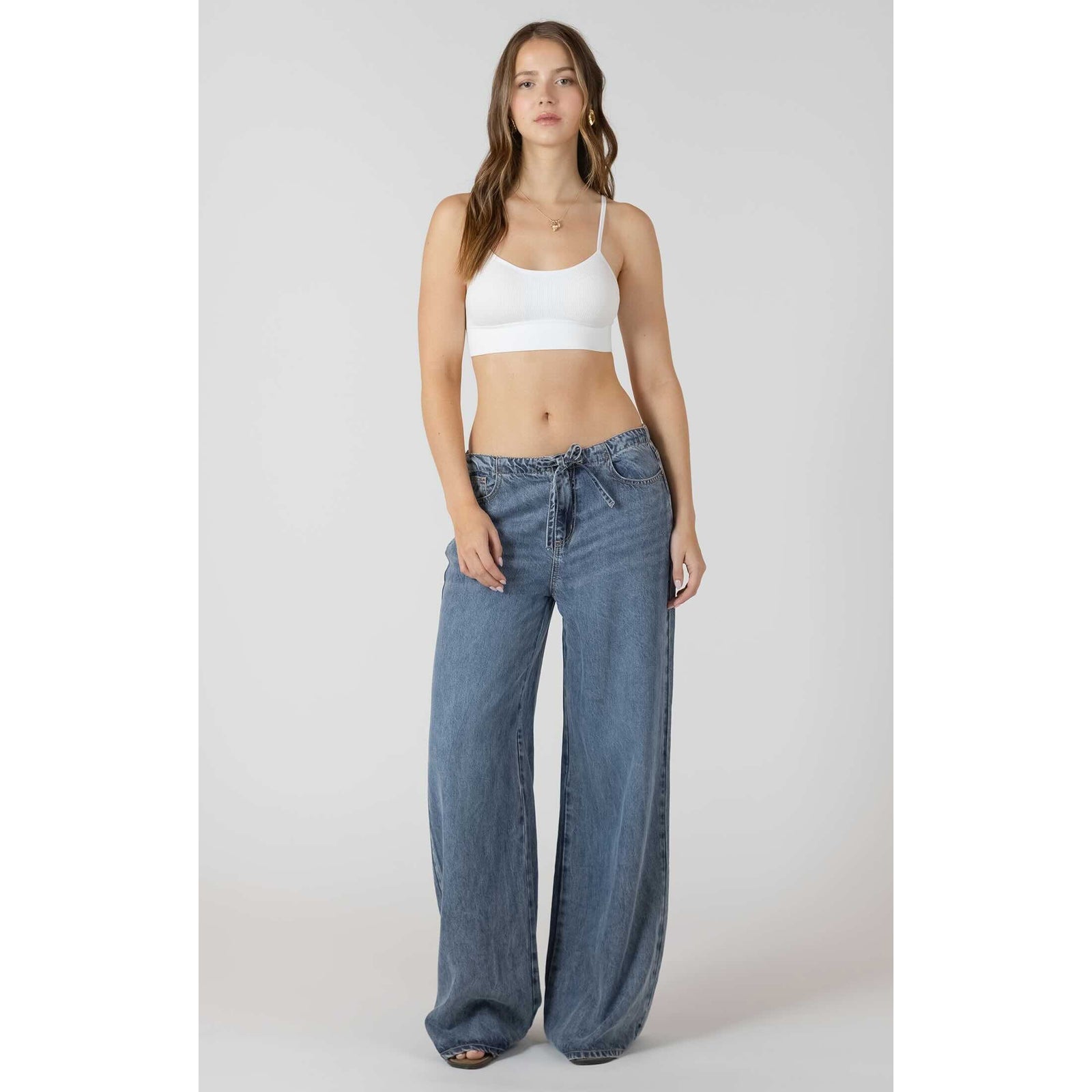 Model wears Dex Drawstring Wide Leg Denim Pant in light indigo wash with adjustable drawstring waist.