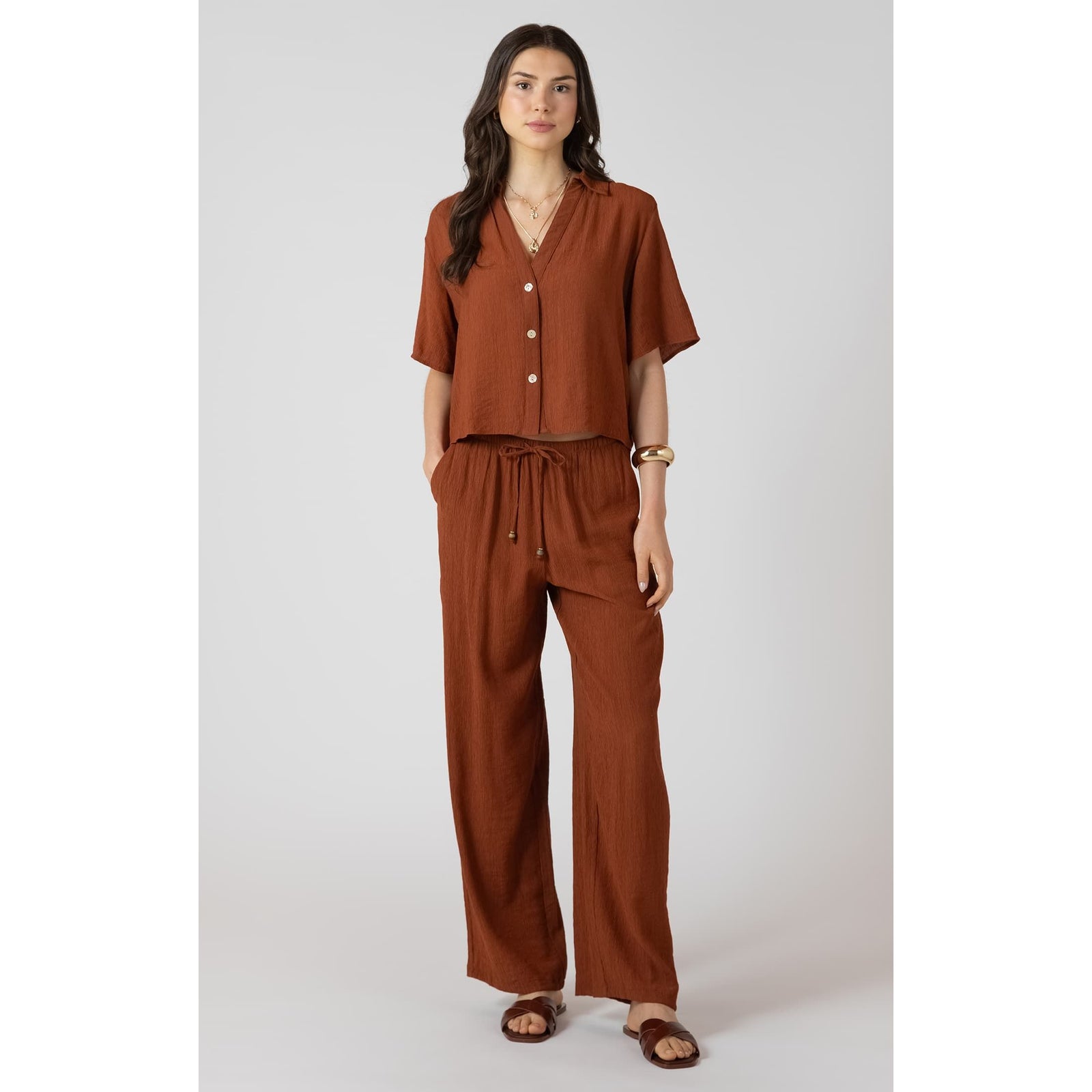 Rust Dex Drawstring Wide Leg Pants on a model with a matching top; breathable fabric, adjustable drawstring waist.