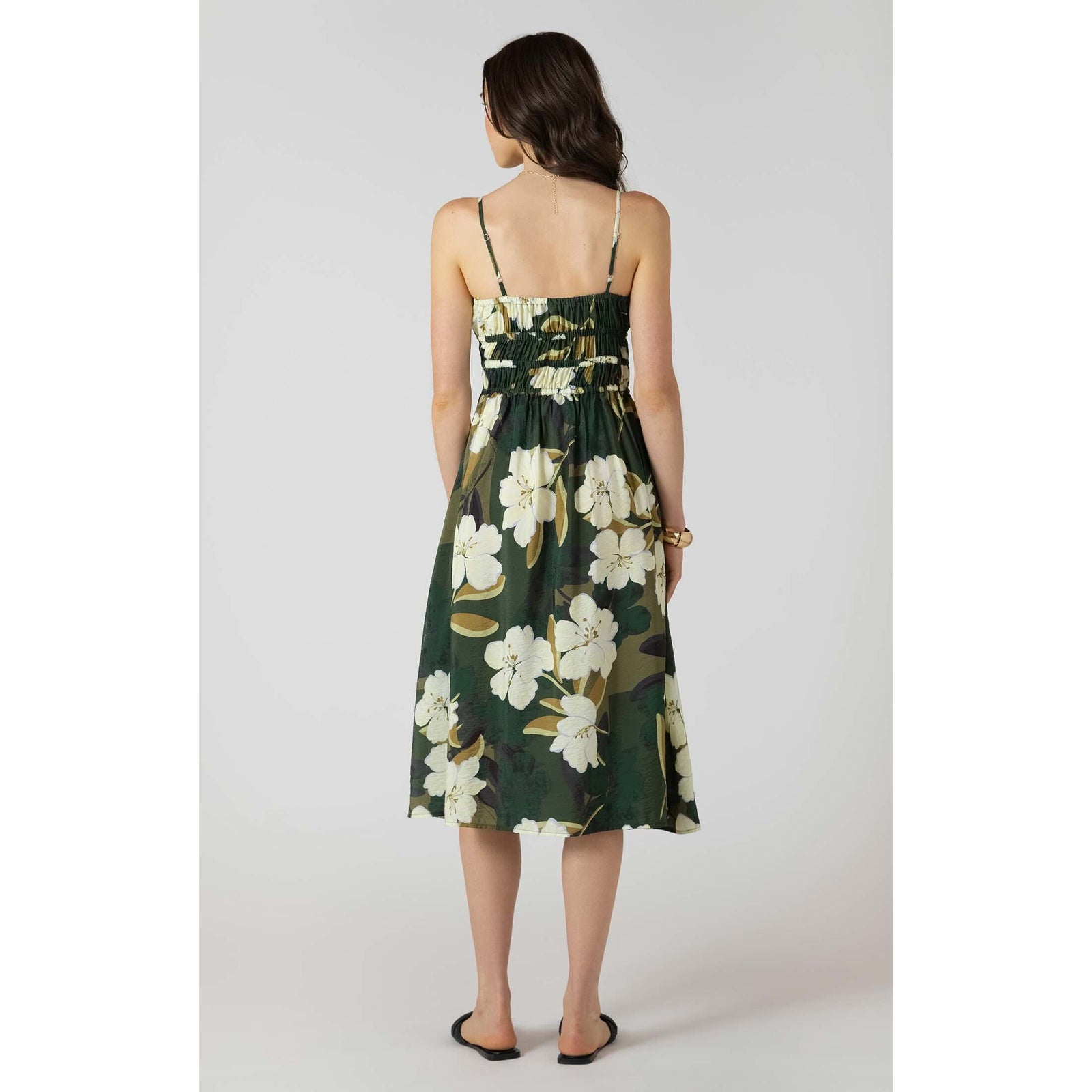 Dex Elastic Waist Midi Dress in dark-green floral print with smocked waist and spaghetti straps worn by a model.