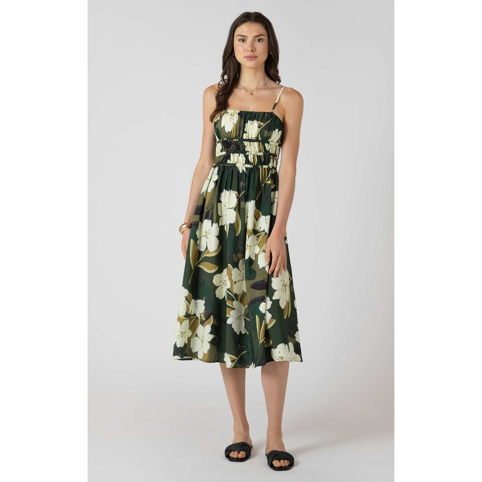 Model wearing Dex Elastic Waist Midi Dress in green floral print with spaghetti straps and an elastic waistband.
