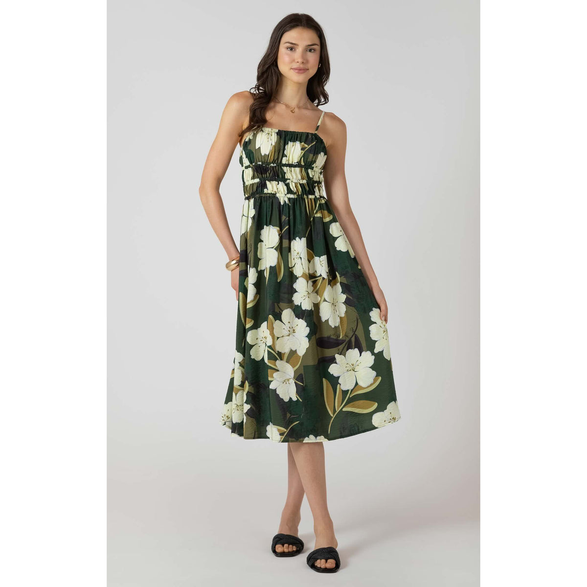 Dex Elastic Waist Midi Dress in dark-green floral print with smocked waist and spaghetti straps worn by a model.