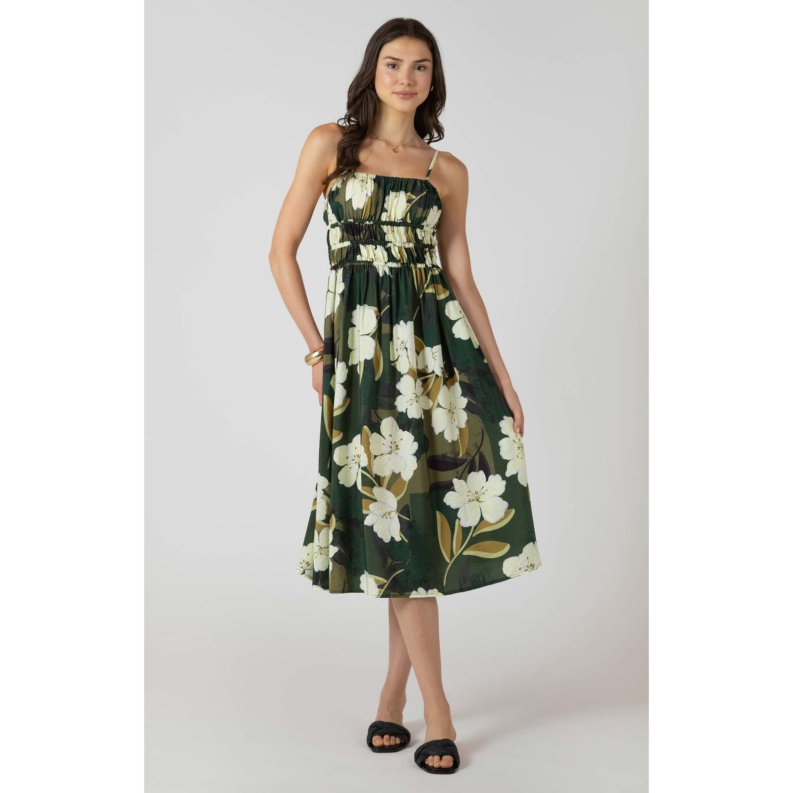Dex Elastic Waist Midi Dress in dark-green floral print with smocked waist and spaghetti straps worn by a model.