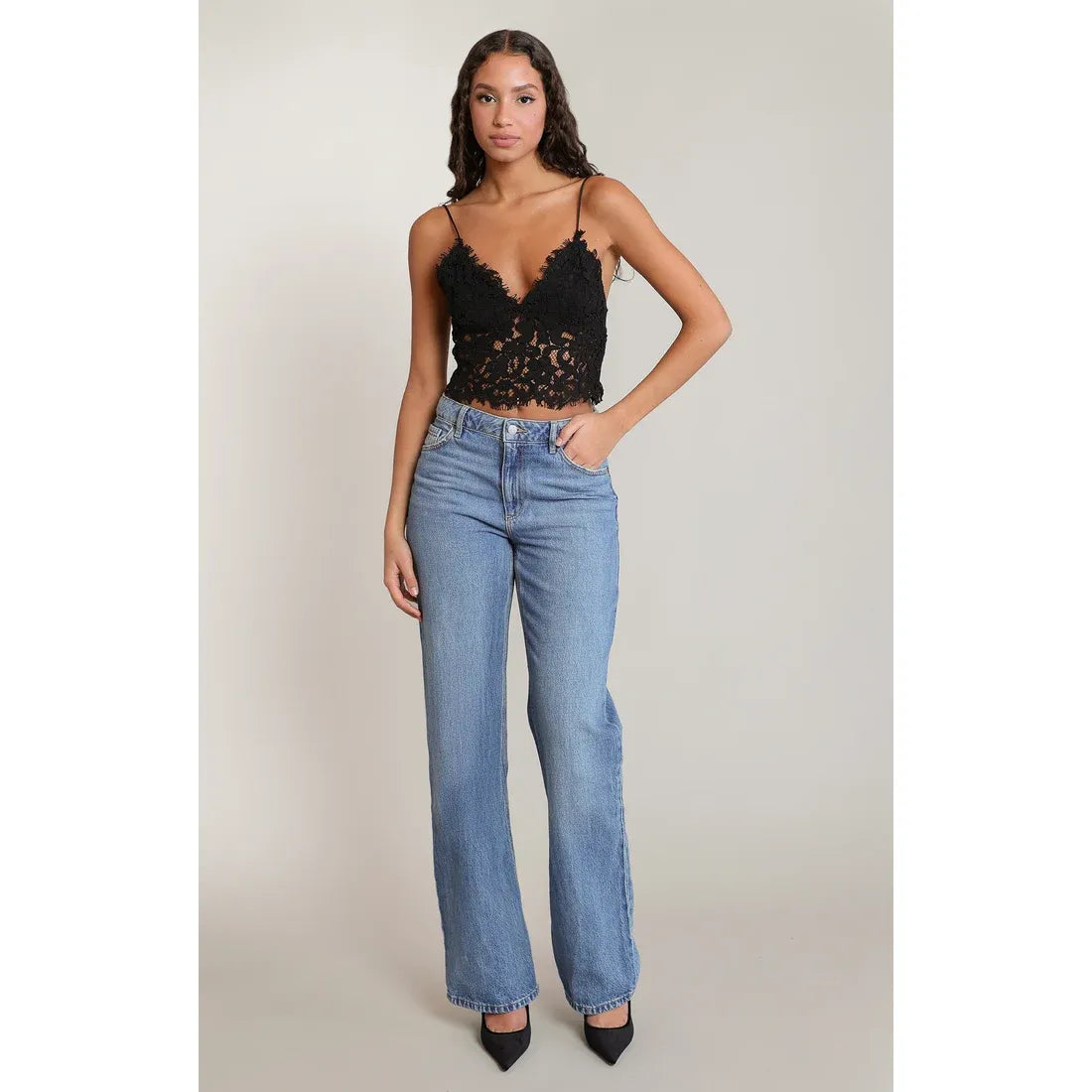 Black lace Dex embroidered cami top with thin straps, styled with high-waist blue jeans and black heels for a boho-casual look.