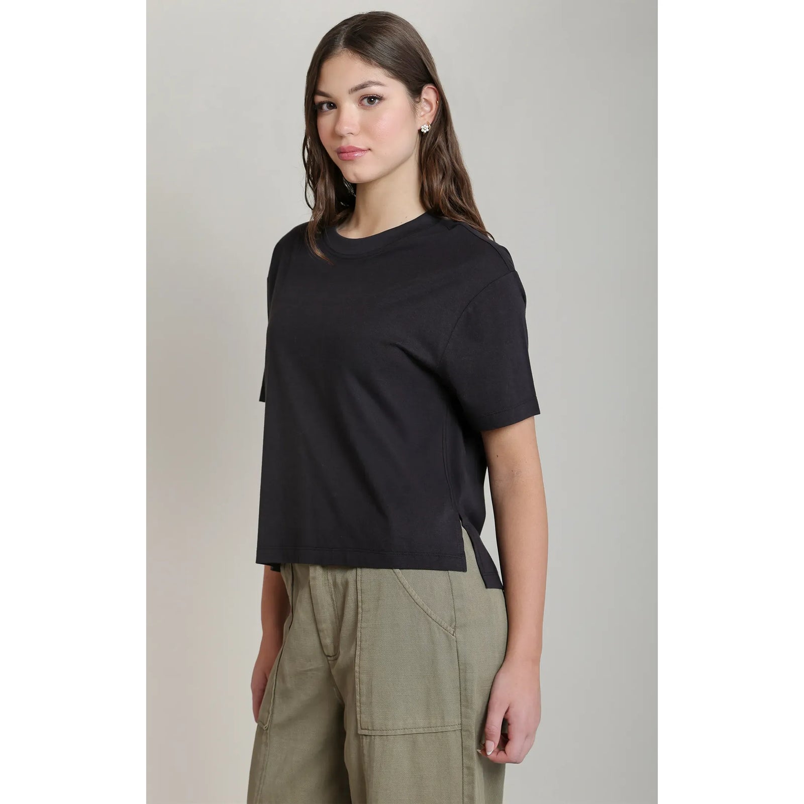 Black short-sleeved essential tee with a relaxed fit, round neck, and side slits for comfortable everyday styling.