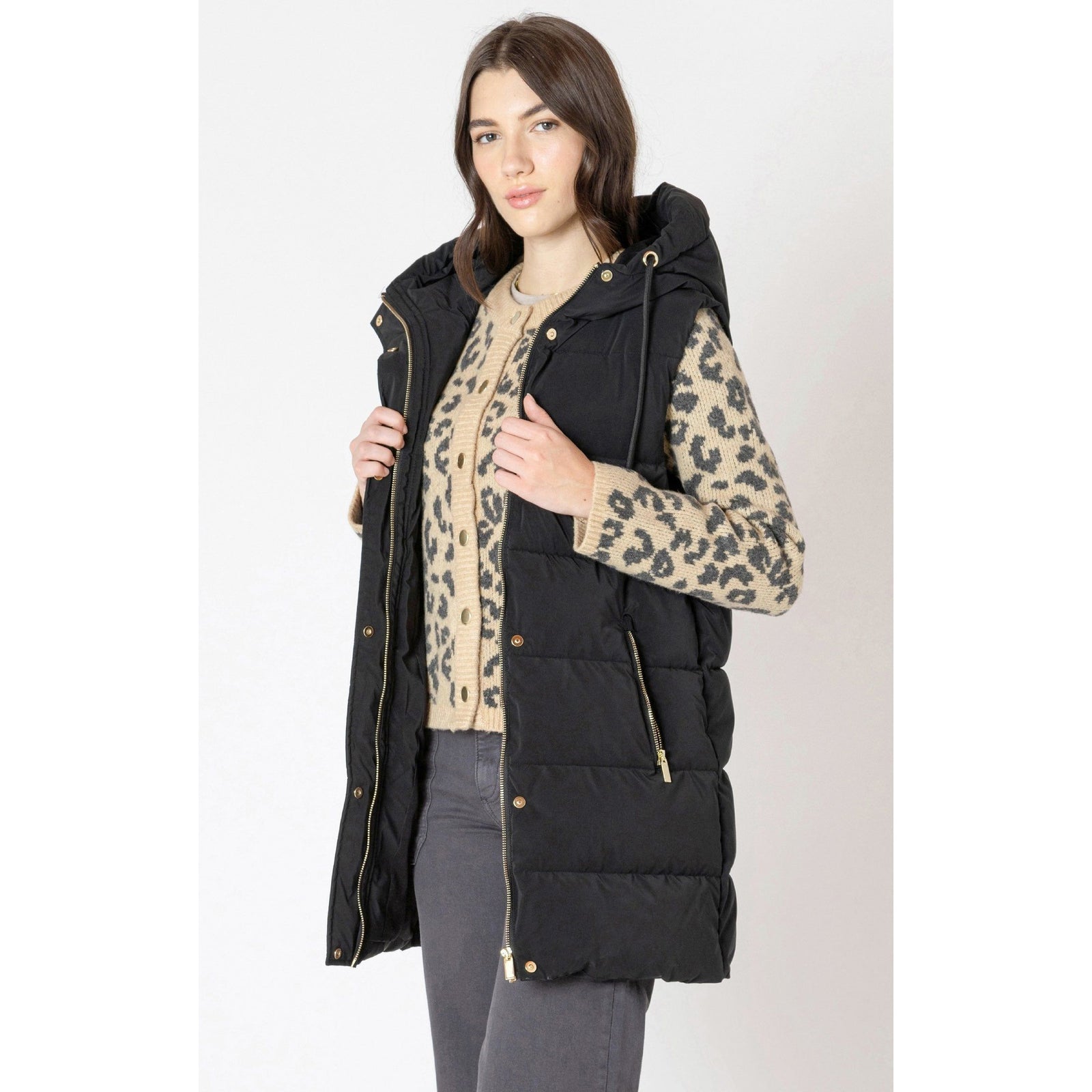 Dex Hooded Puffer Vest worn black puffer with hood layered over leopard cardigan.