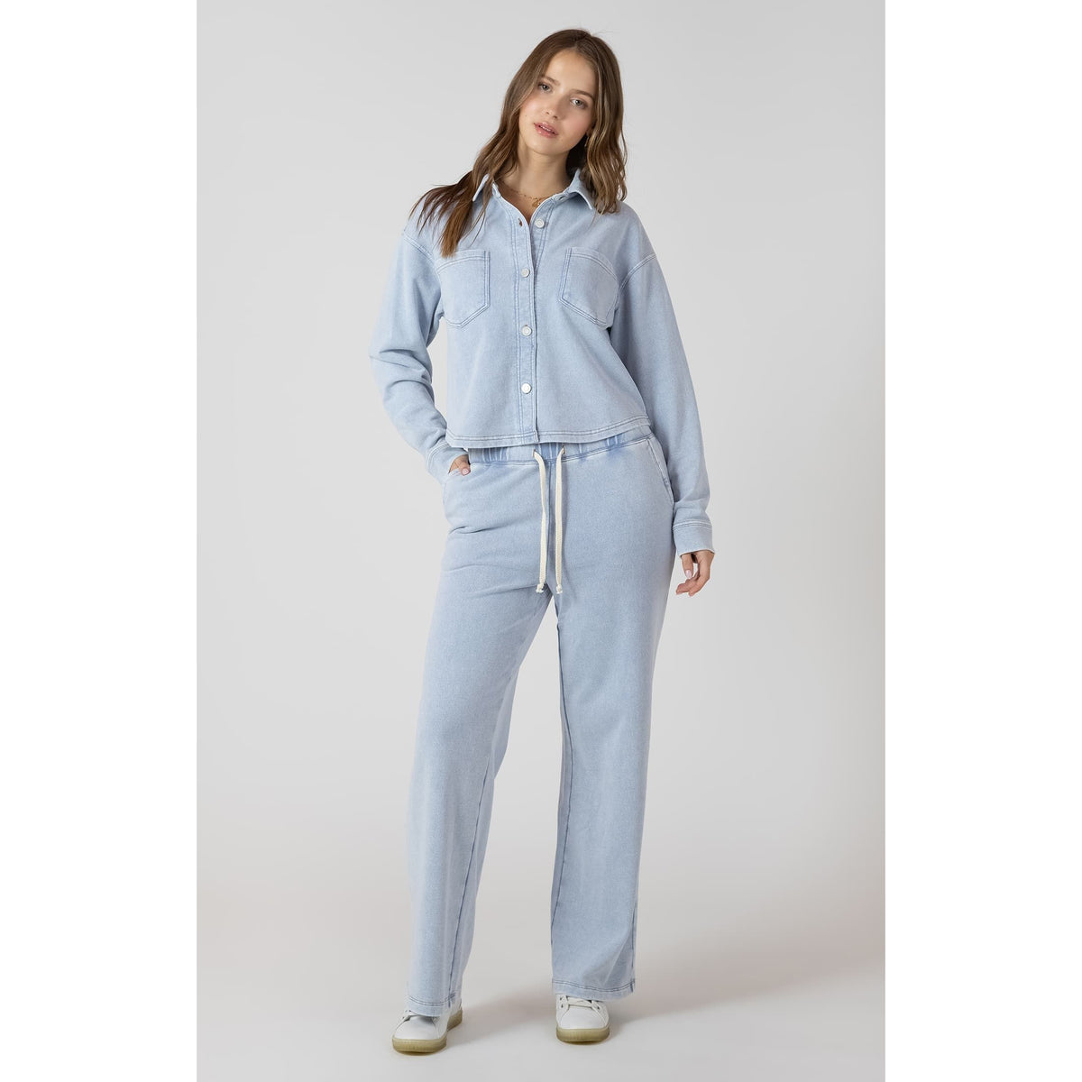 Model in Dex Knit Lounge Pant set: light blue knit with drawstring waist and matching button-down top.