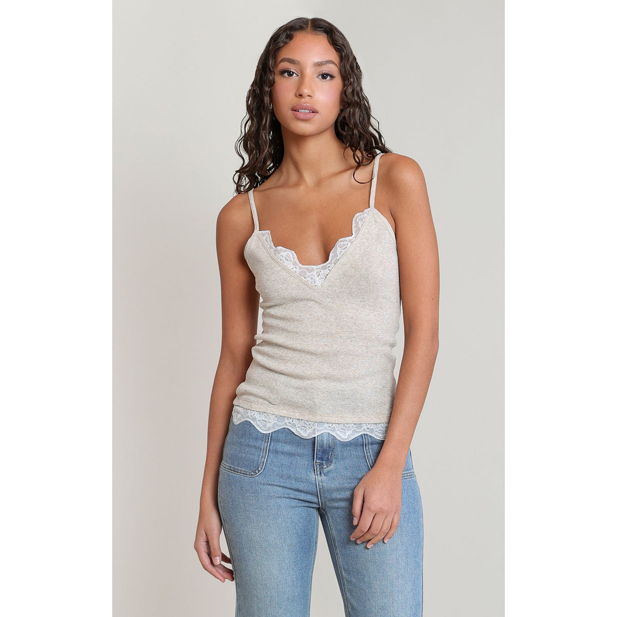 Dex Lace Cami: beige lace-trim V-neck camisole on a model, ideal for layering.