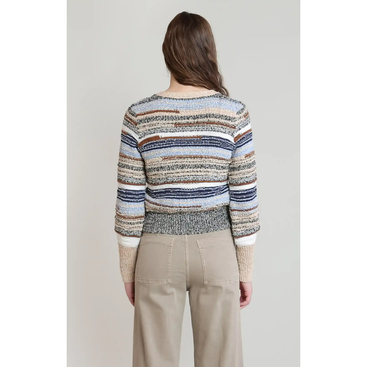 Back view of a soft-hued melange striped cardigan in navy, beige, and white. A relaxed-fit, long-sleeve fall essential featuring a textured cotton-polyester blend.