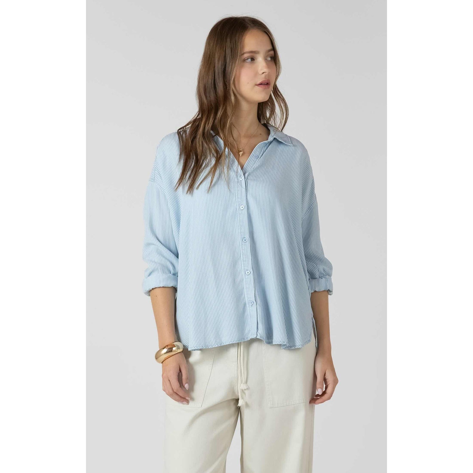Dex Relaxed Button Front Shirt in light blue striped weave, a loose-fit blouse with rolled sleeves.