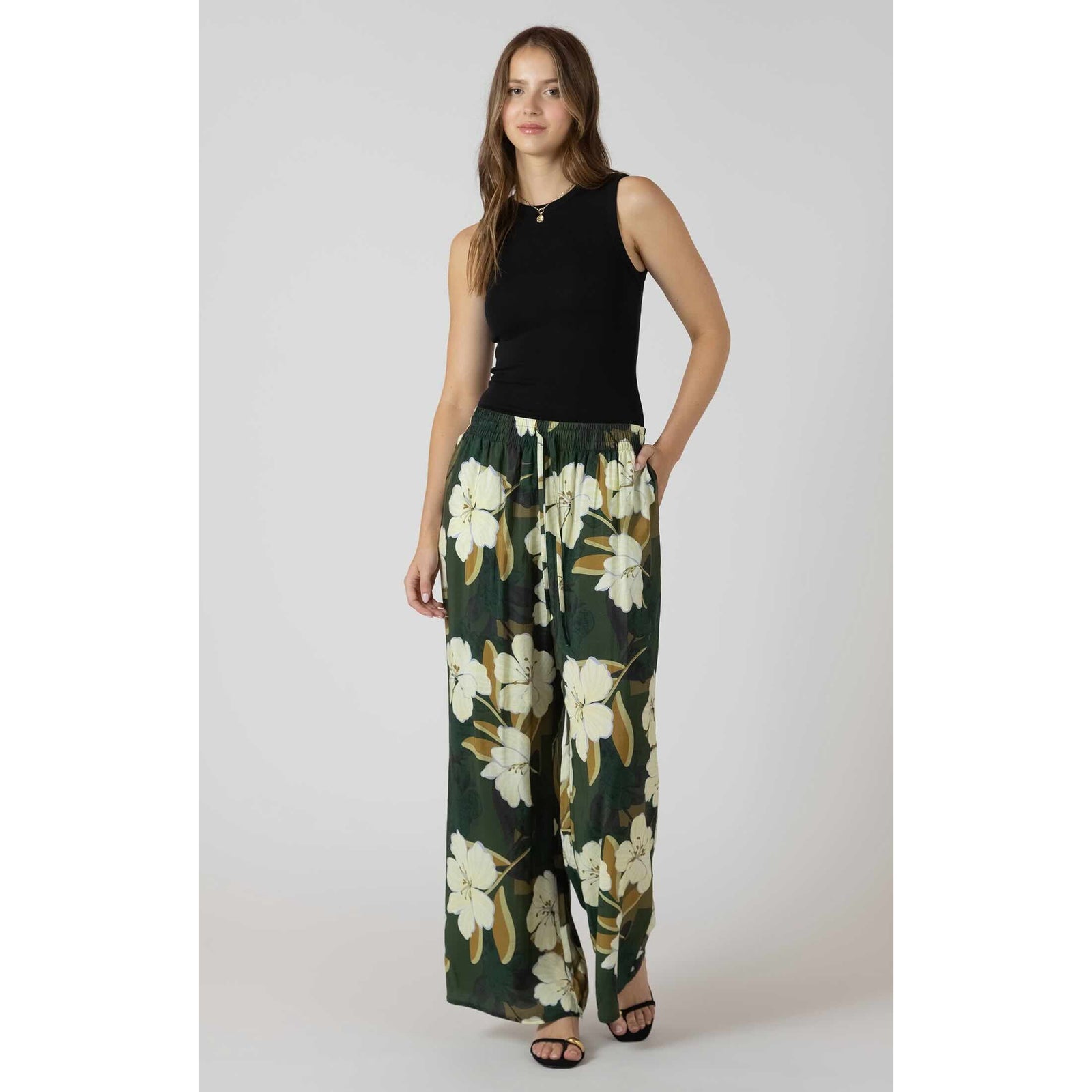 Dex Ribbed Tank black sleeveless top paired with green floral wide-leg pants on model