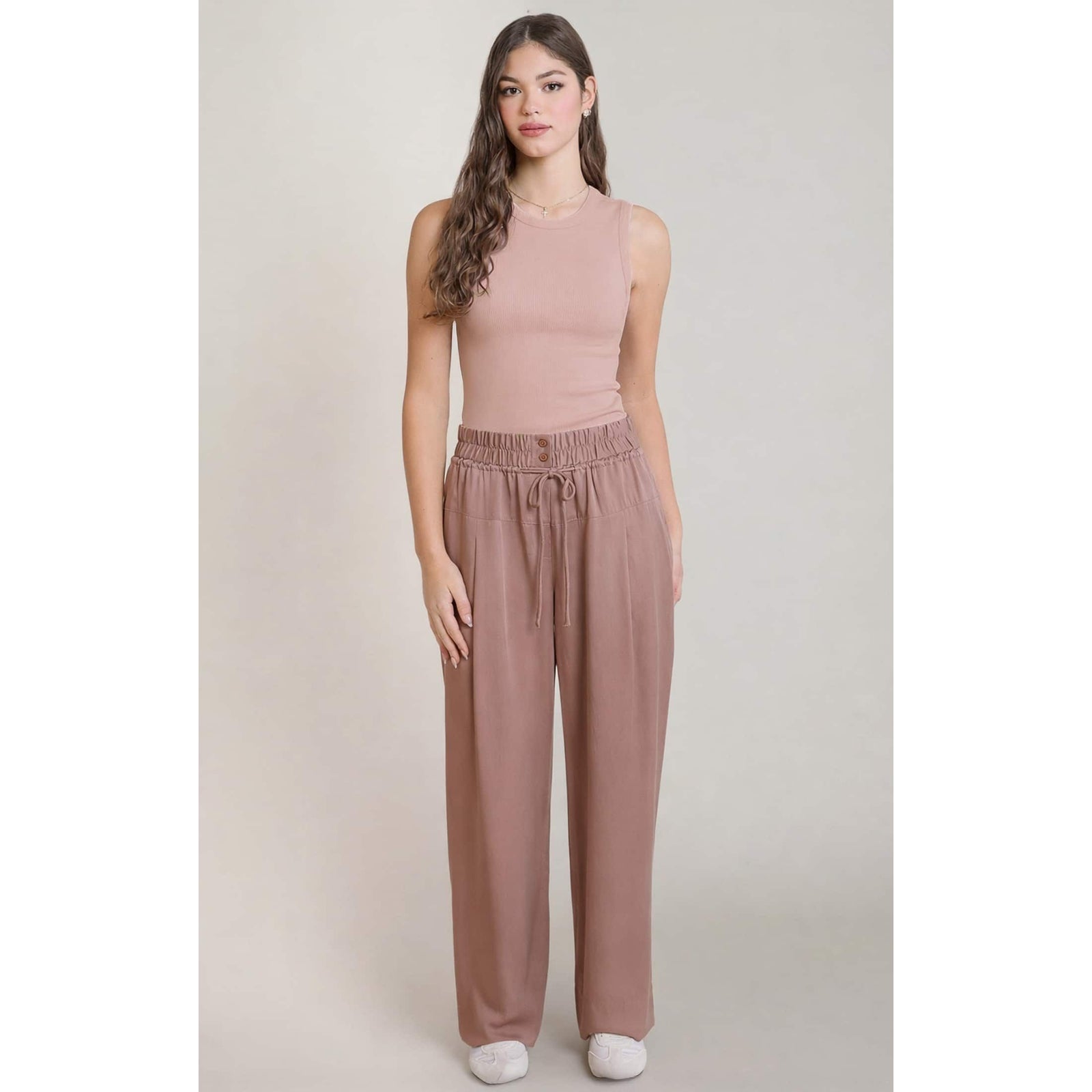 Dex Ribbed Tank in dusty-rose ribbed knit with stretch, shown on a model for a sleek silhouette.