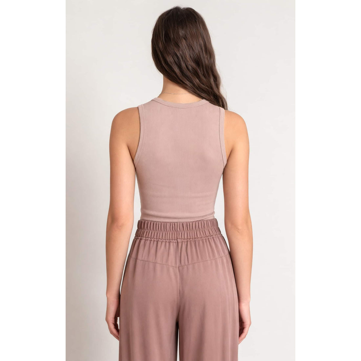 Dex Ribbed Tank in dusty pink, back view highlighting ribbed knit fabric and sleeveless silhouette.