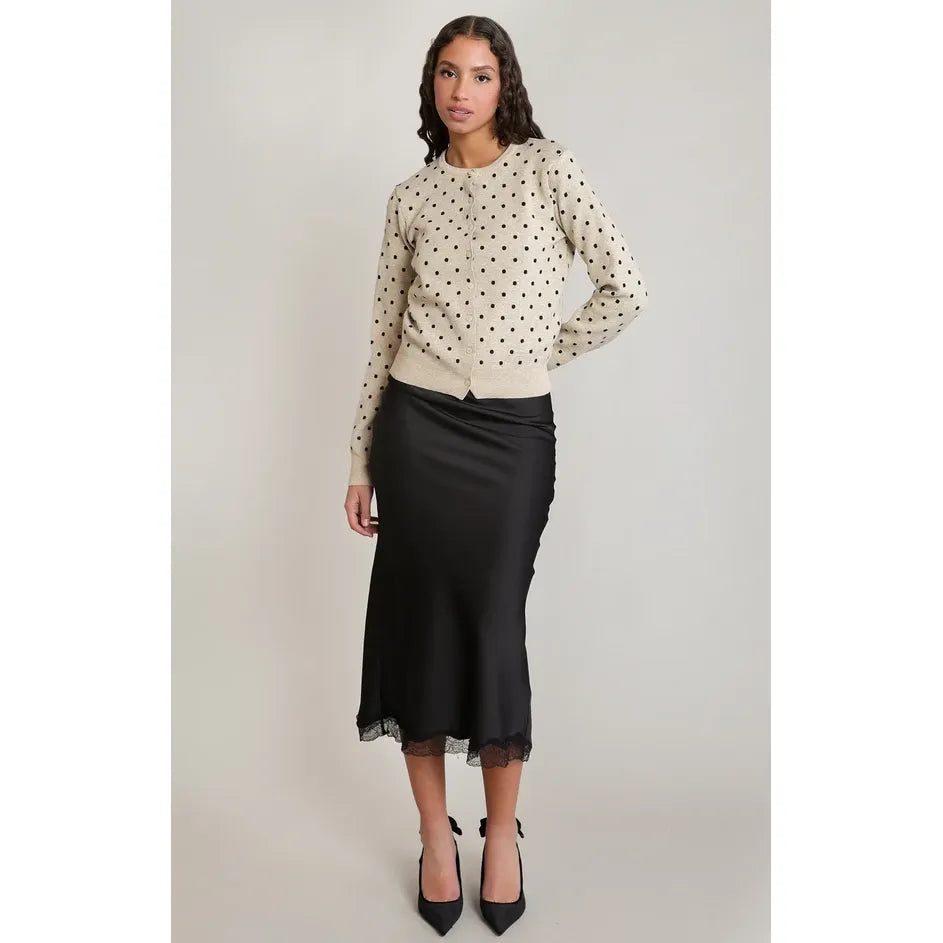 Black satin midi skirt with delicate lace trim hem, featuring a fluid drape and flattering silhouette.