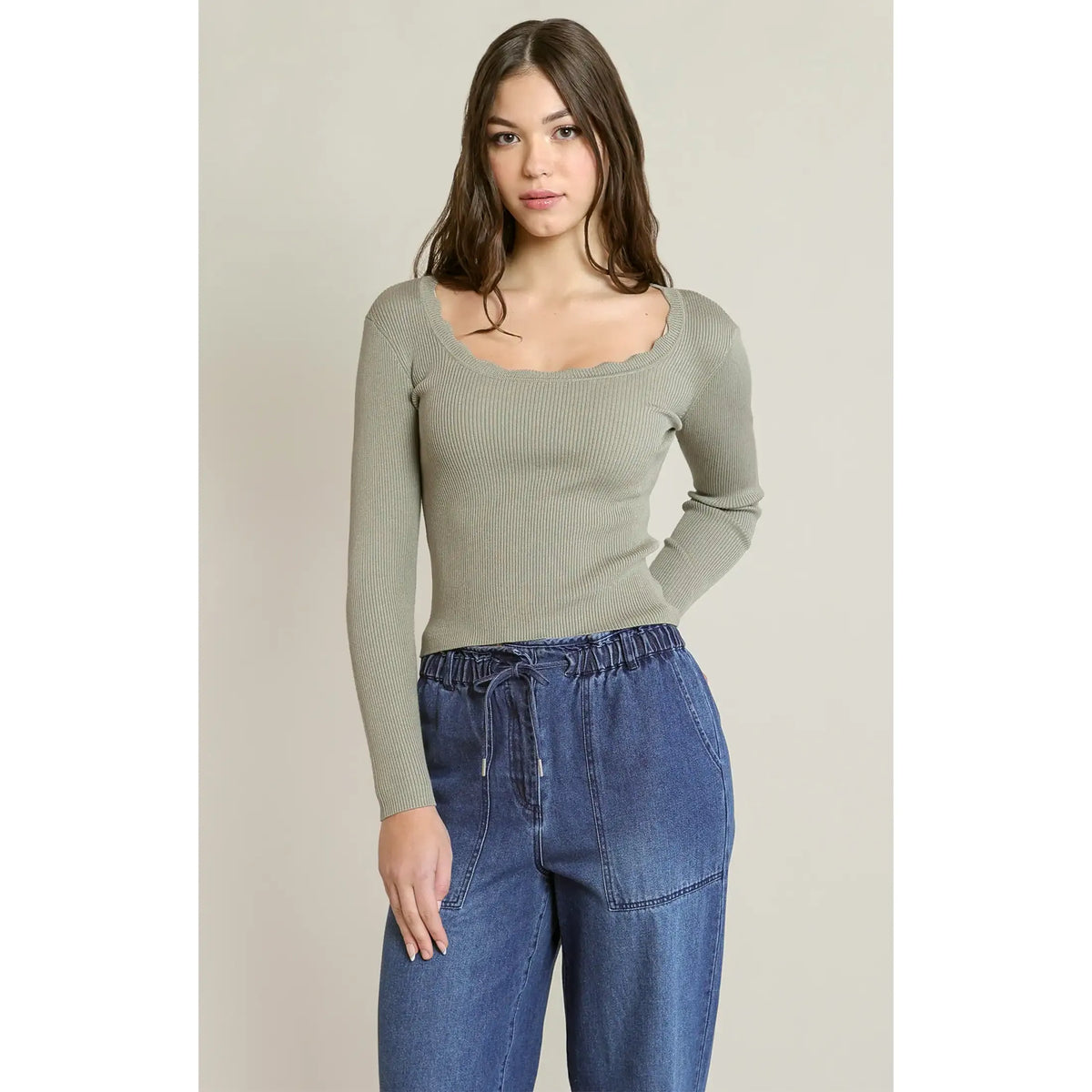 Sage green rib knit top with scalloped neckline and long sleeves, styled with denim.