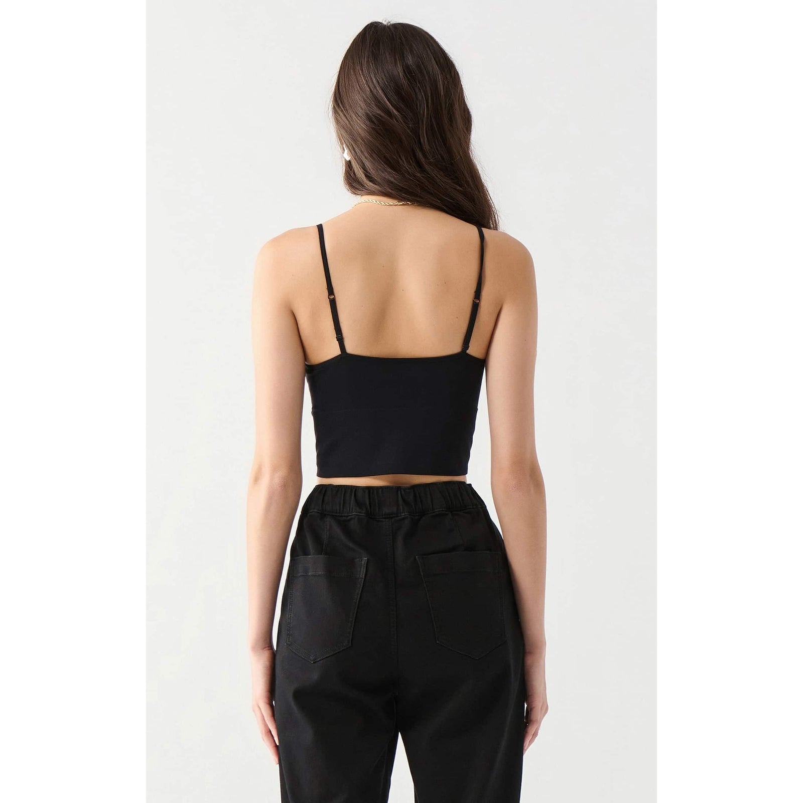 Dex Seamless Bra Top in black, back view with adjustable straps, cropped length, cotton-spandex blend.