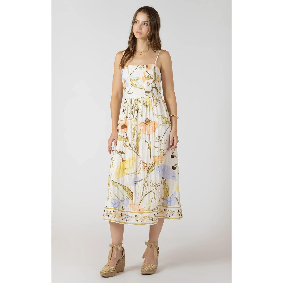 Dex Smocked Midi Dress on model with delicate straps, smocked bodice, and a pastel floral print.
