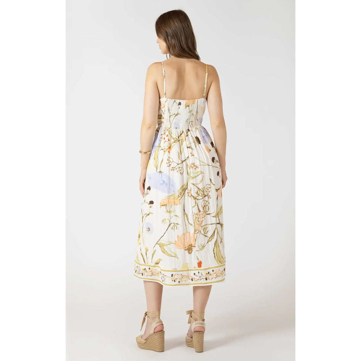 Dex Smocked Midi Dress with smocked bodice and floral print, back view showing thin straps and flowy midi skirt.