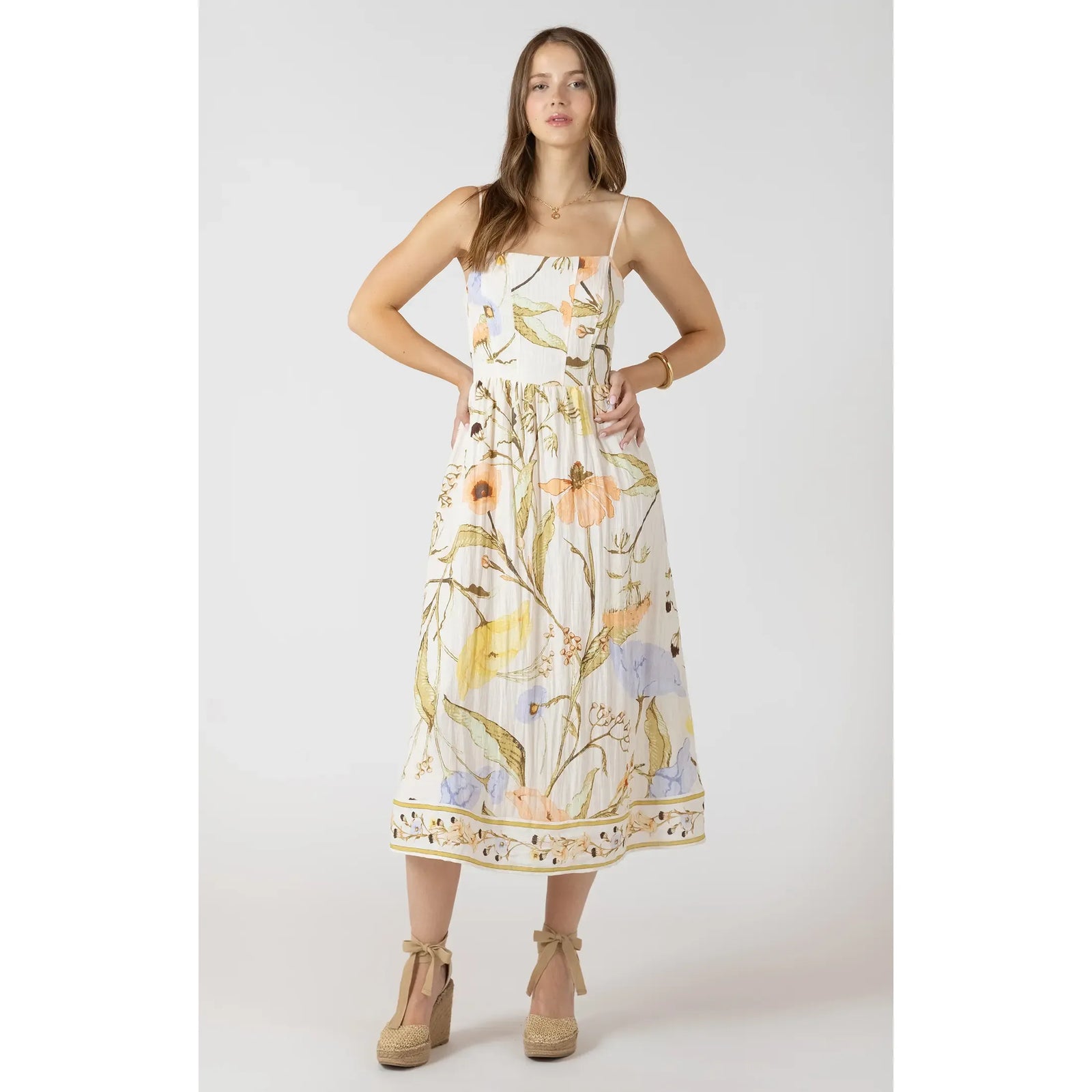 Dex Smocked Midi Dress with floral print, thin straps and smocked bodice on a model.