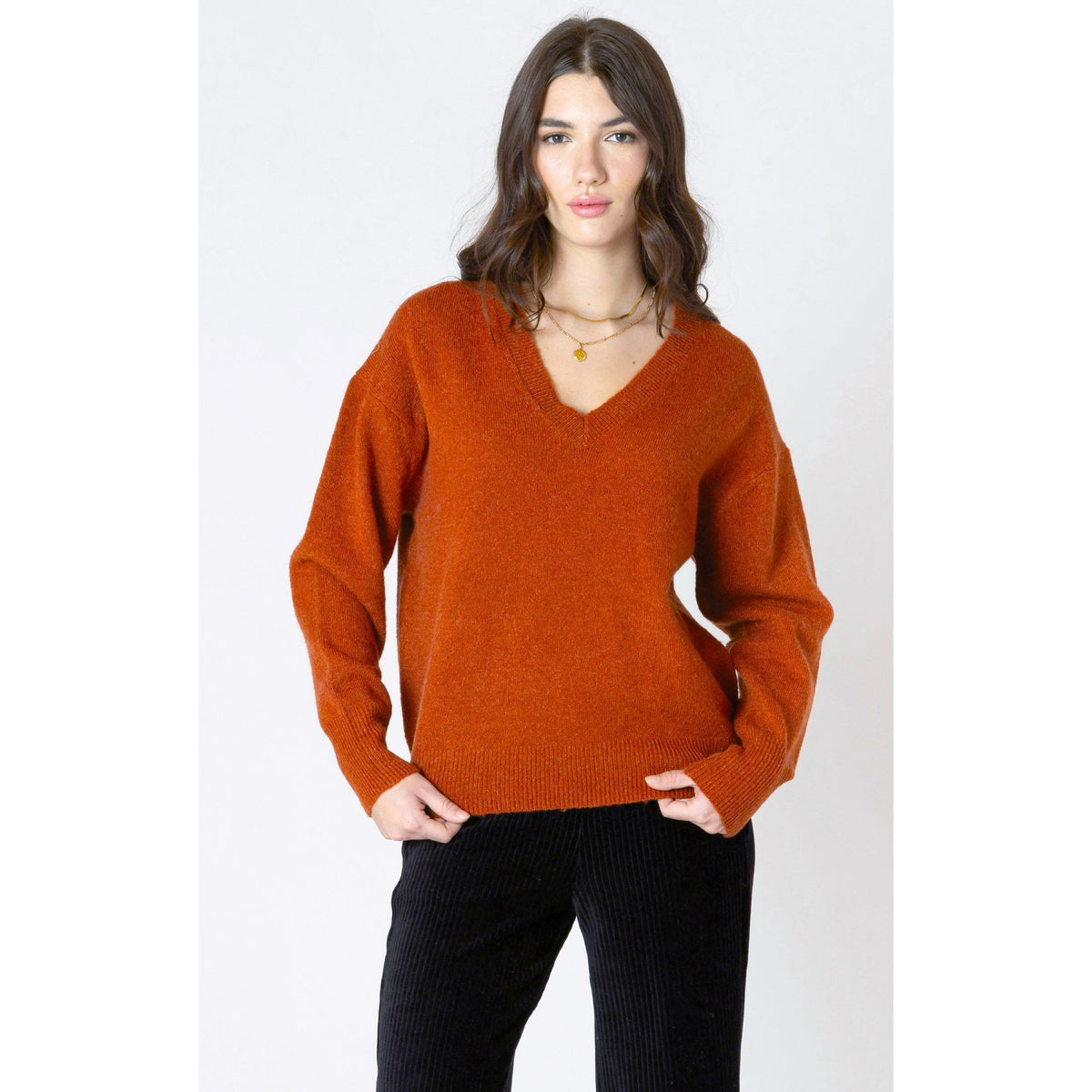 Cozy up in the Dex Soft Touch Sweater, a stylish burnt orange piece perfect for autumn days.