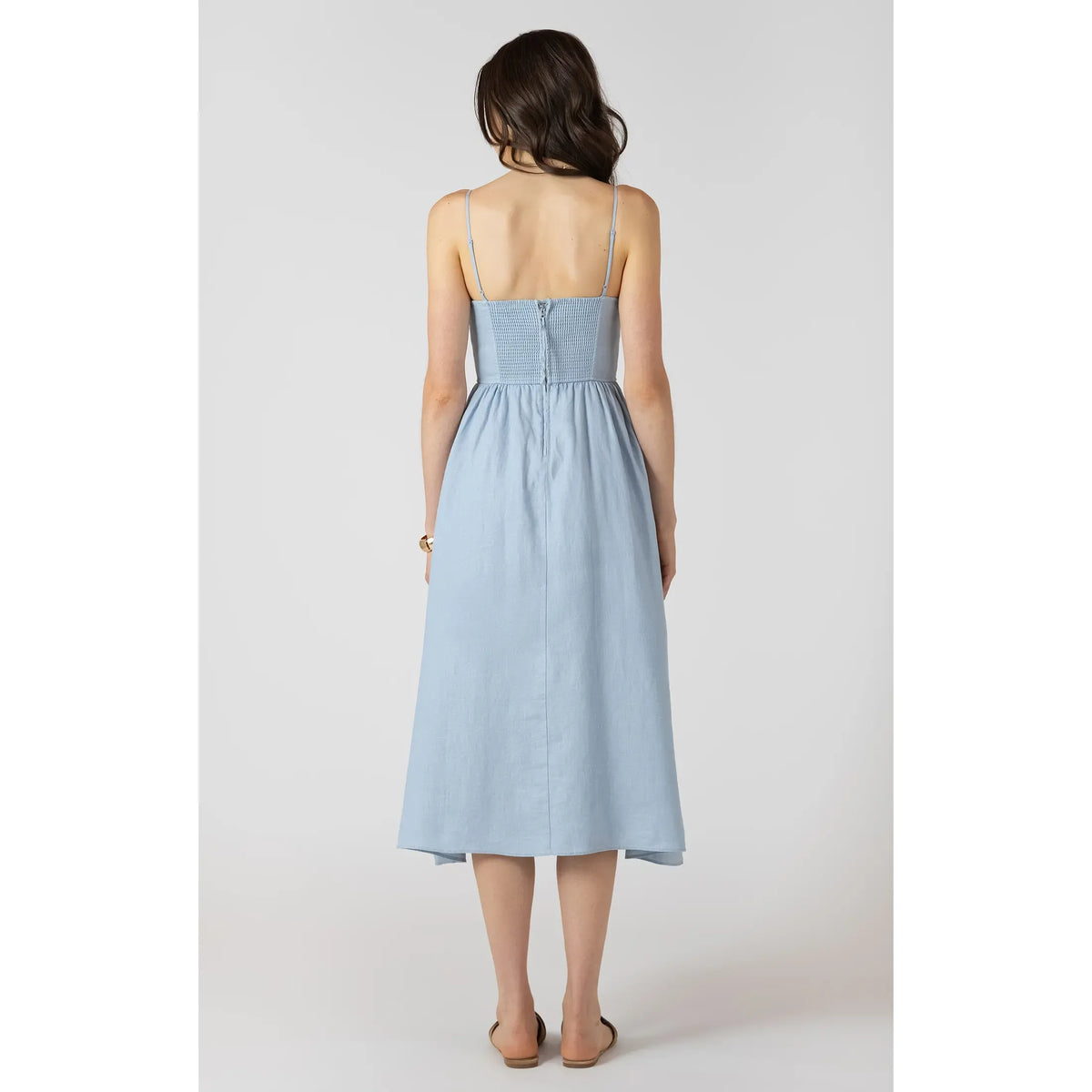 Dex V Waist Maxi Dress in light blue, back view with smocked bodice, V-waist and flowing long skirt.