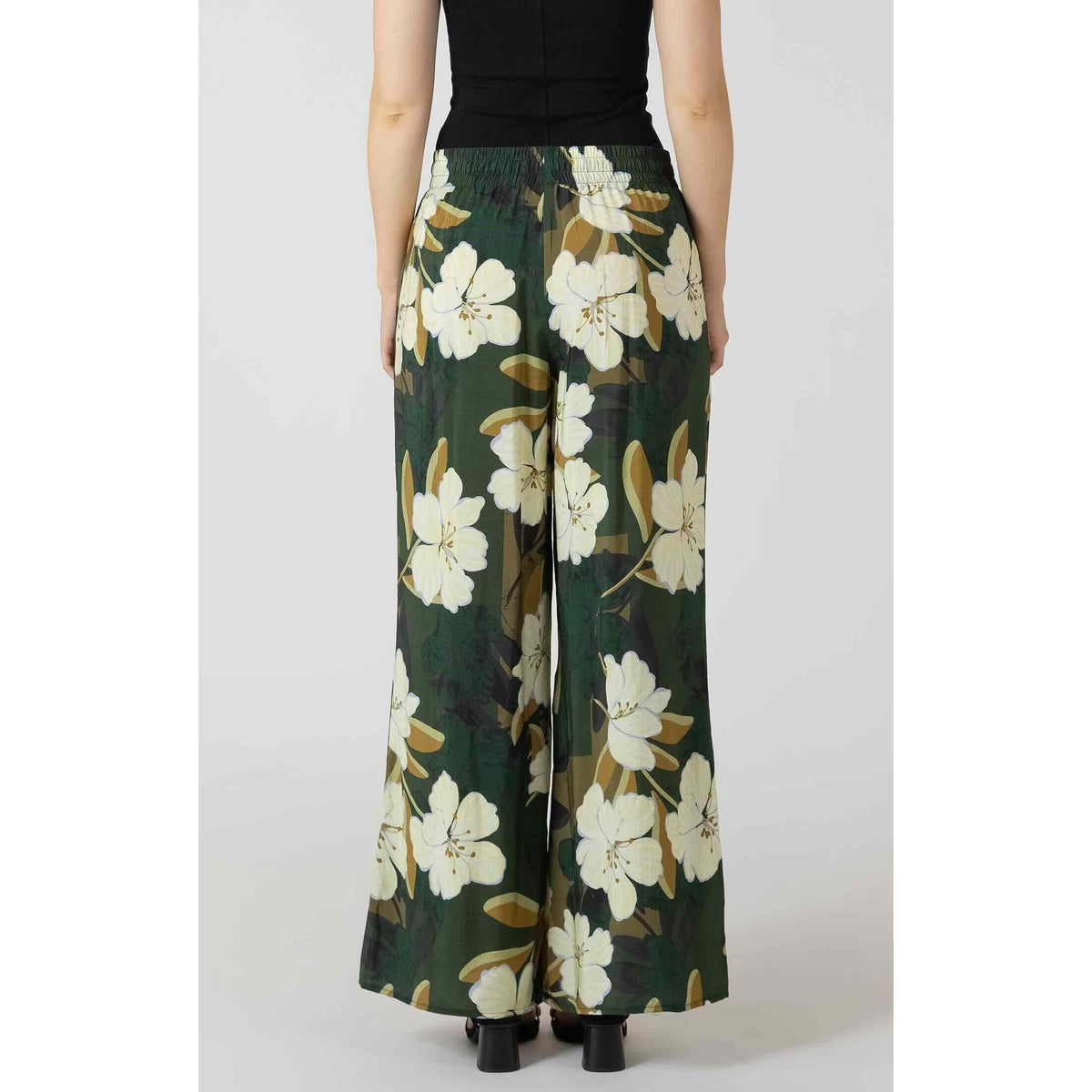 Back view of Dex Wide Leg Flowy Pants in green with white floral print and elastic waistband, wide-leg silhouette.
