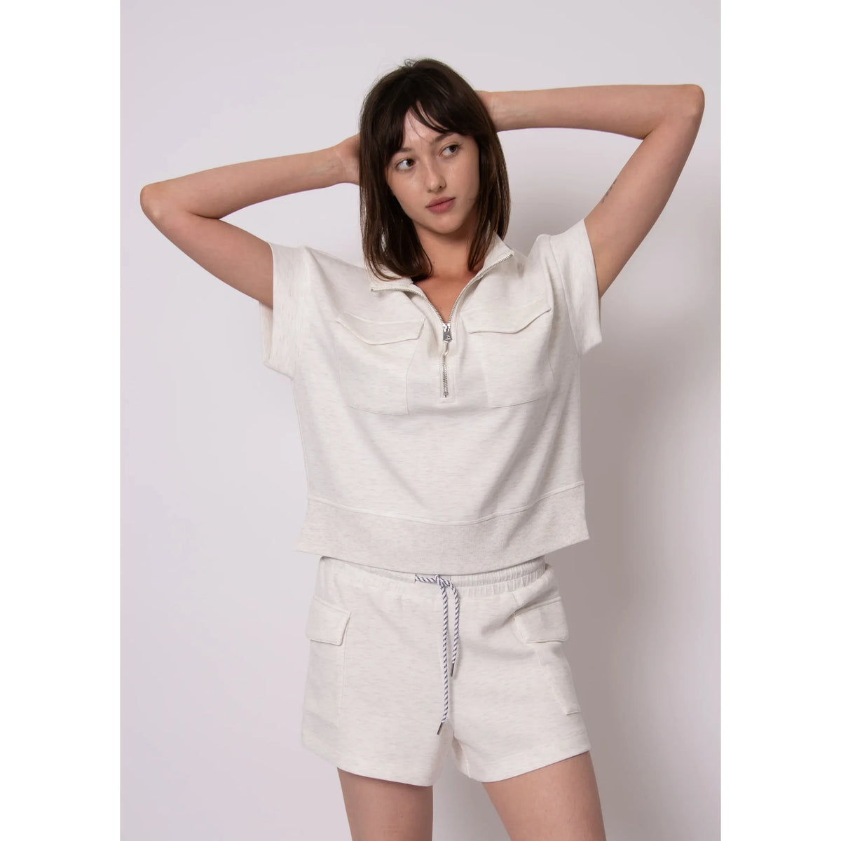 Dua Soft Knit 1/2 Zip Top in light heather with short sleeves and zipper, modeled with matching drawstring shorts.