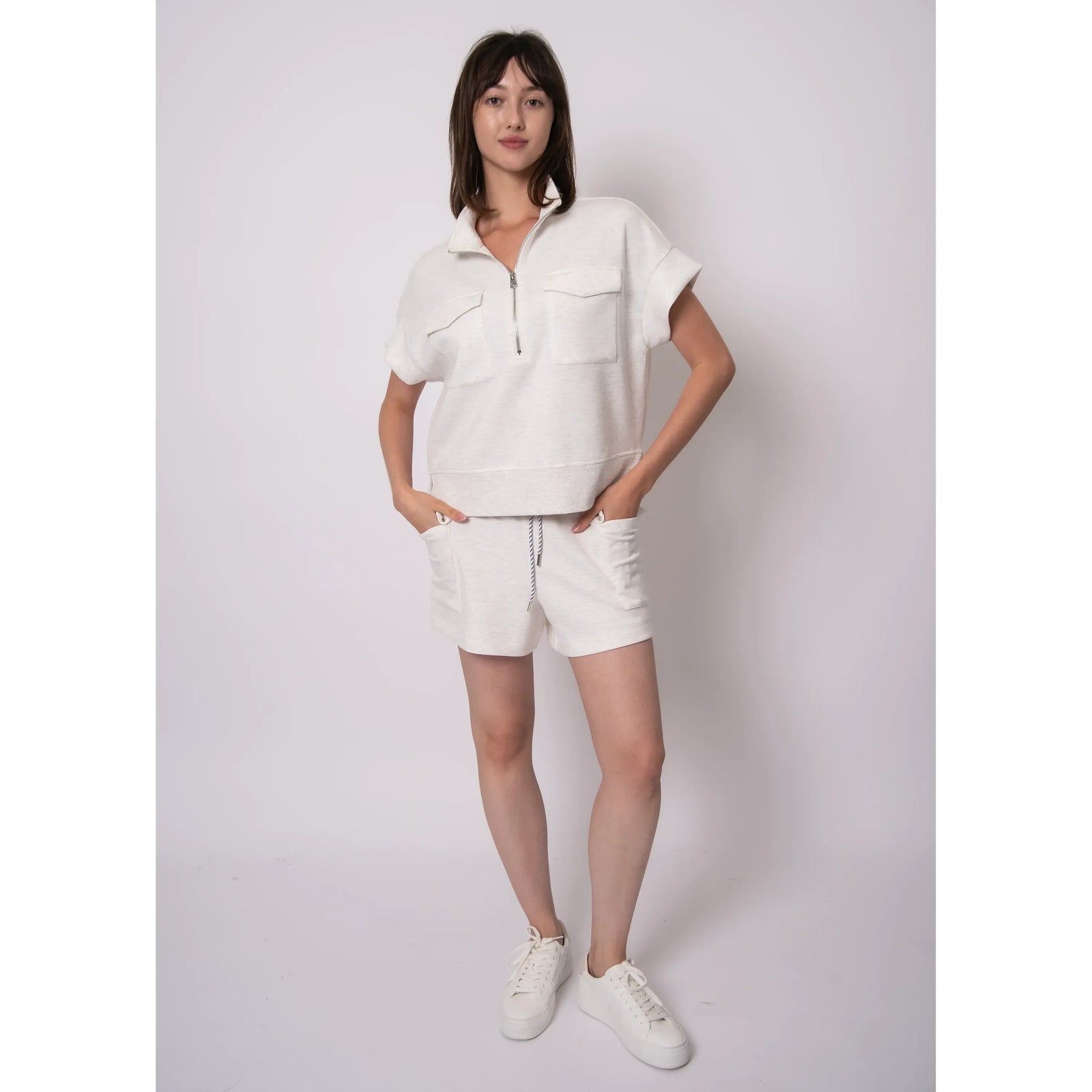 Dua Soft Knit 1/2 Zip Top in cream with short sleeves, zip-front and chest pockets, paired with matching shorts.