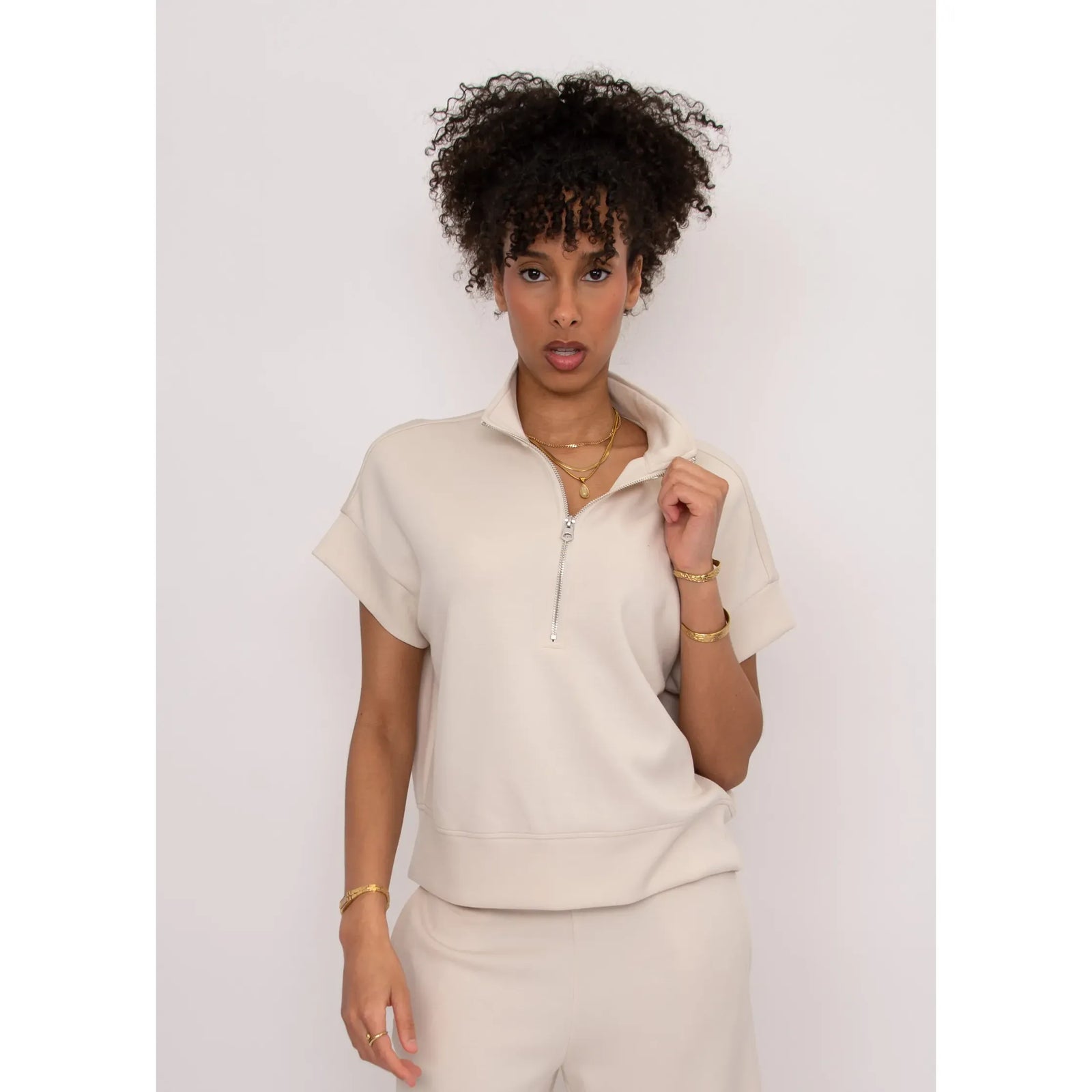 Beige Dua Soft Knit 1/2 Zip Top with short cuffed sleeves and relaxed fit on model.