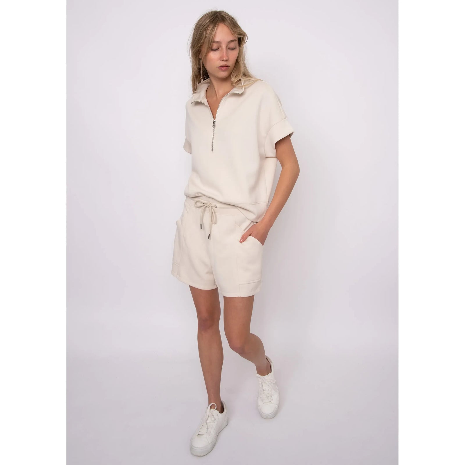 Dua Soft Knit 1/2 Zip Top in cream with short cuffed sleeves and relaxed fit, paired with matching cream shorts.