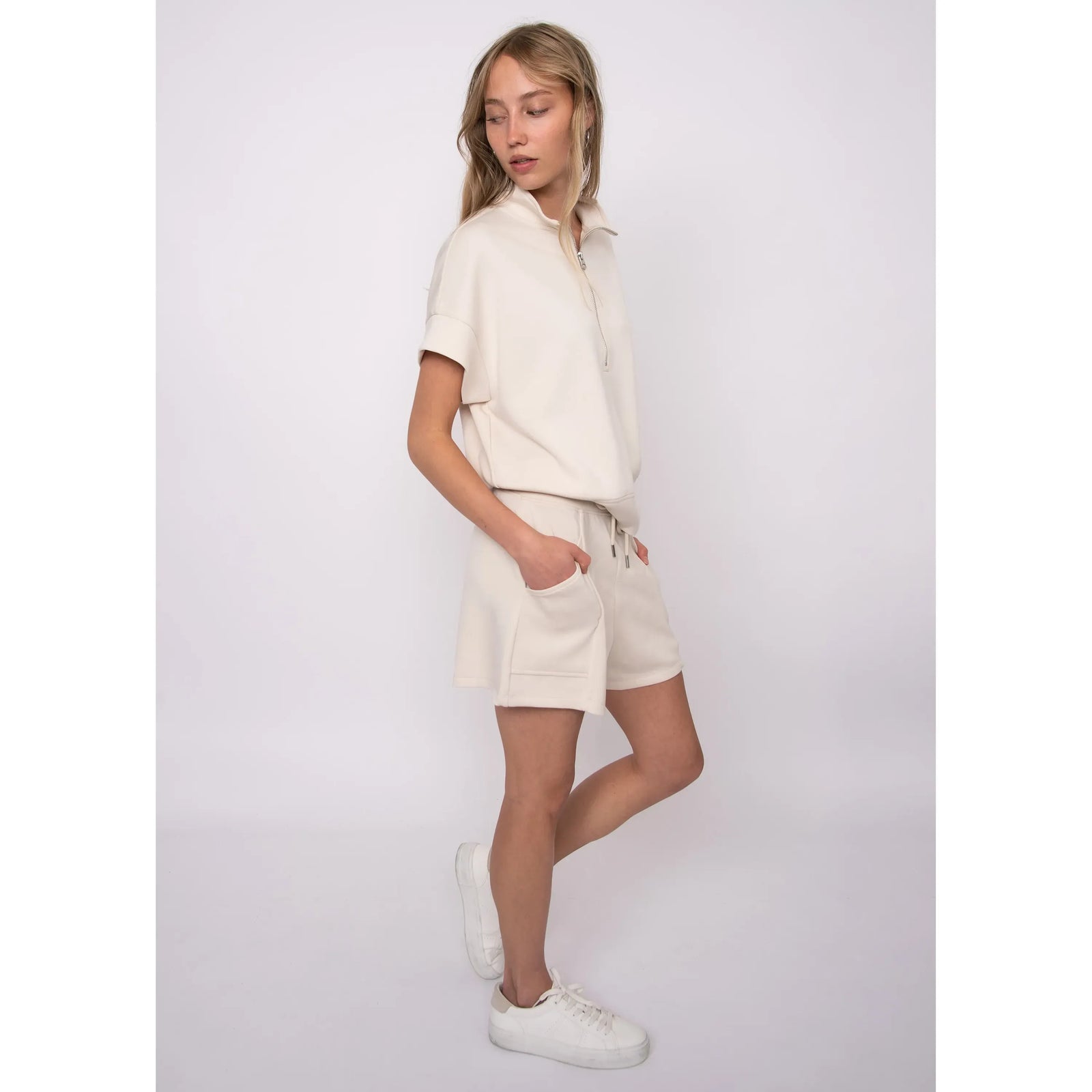 Dua Soft Knit 1/2 Zip Top in cream with short cuffed sleeves and relaxed fit, paired with matching shorts.