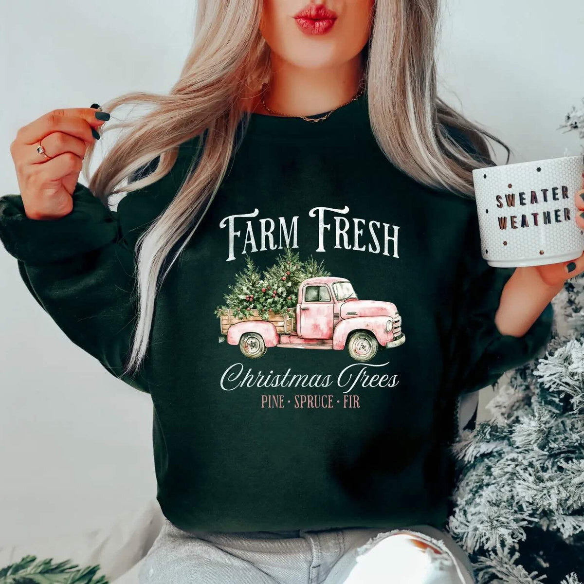 Dark green holiday crewneck featuring a vintage pink truck carrying "Farm Fresh Christmas Trees" graphic.